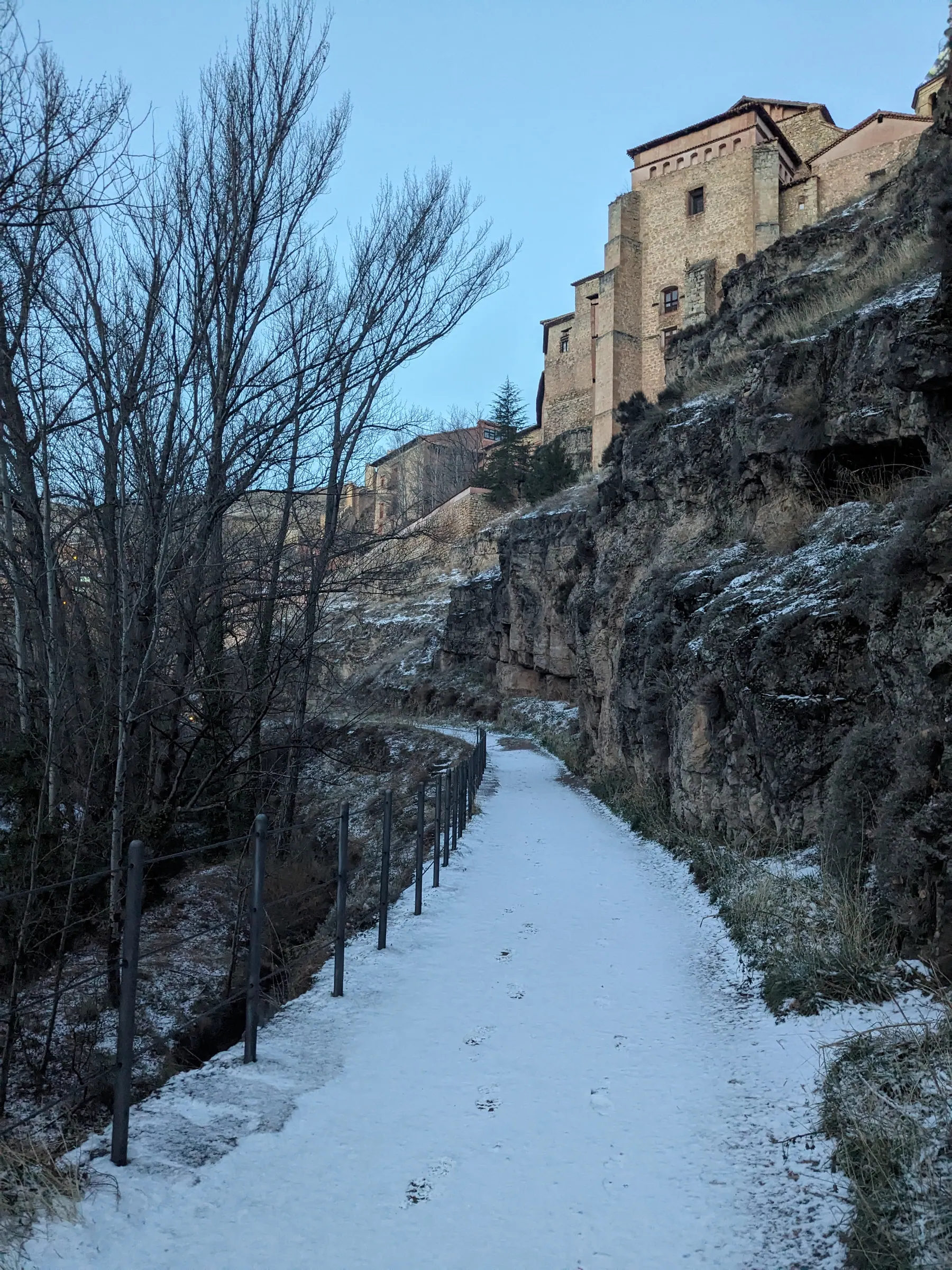 Sandstone cliff face rising from the river gorge trail up to the hanging houses of Albarracín