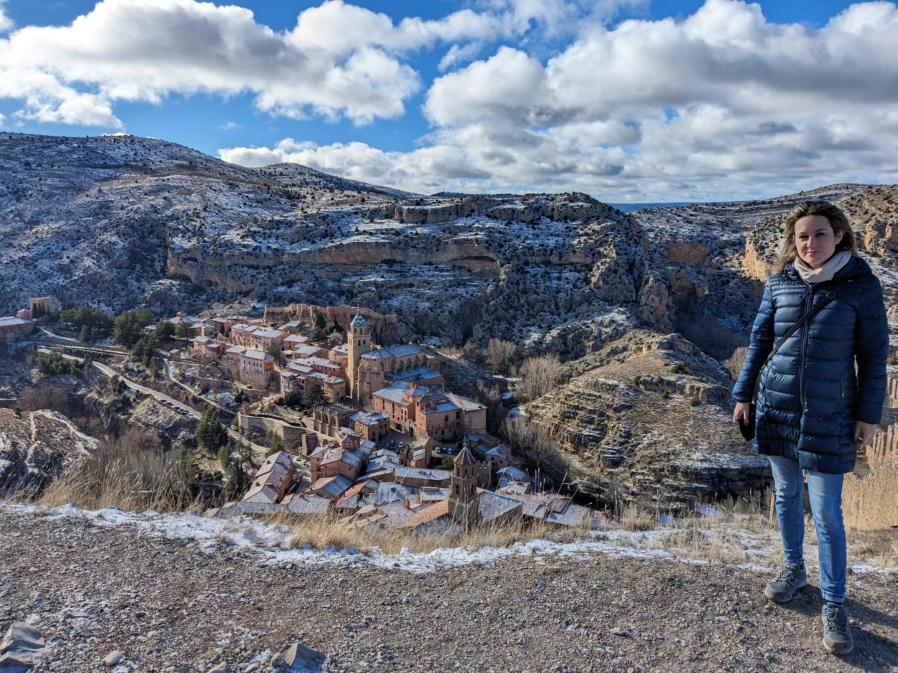 Zane standing at the viewpoint overlooking the snow-dusted medieval village of Albarracín