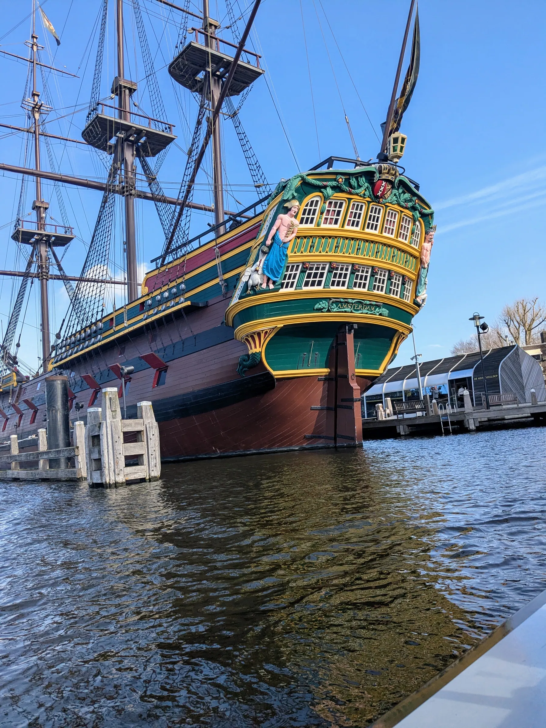 A historic ship seen from the water during a canal boat trip in Amsterdam