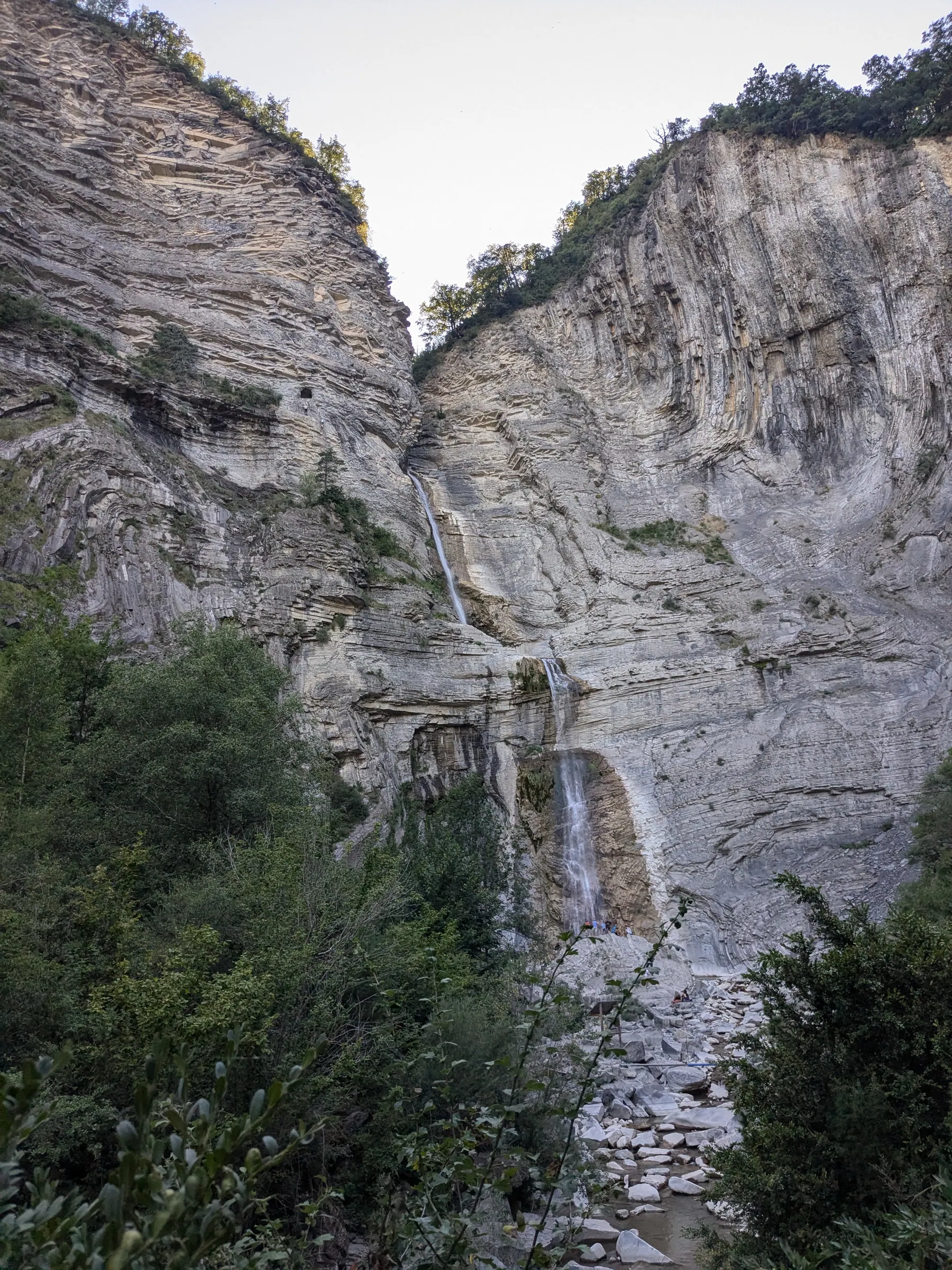 A tall waterfall dropping through a rocky gorge in the Aragonese Pyrenees