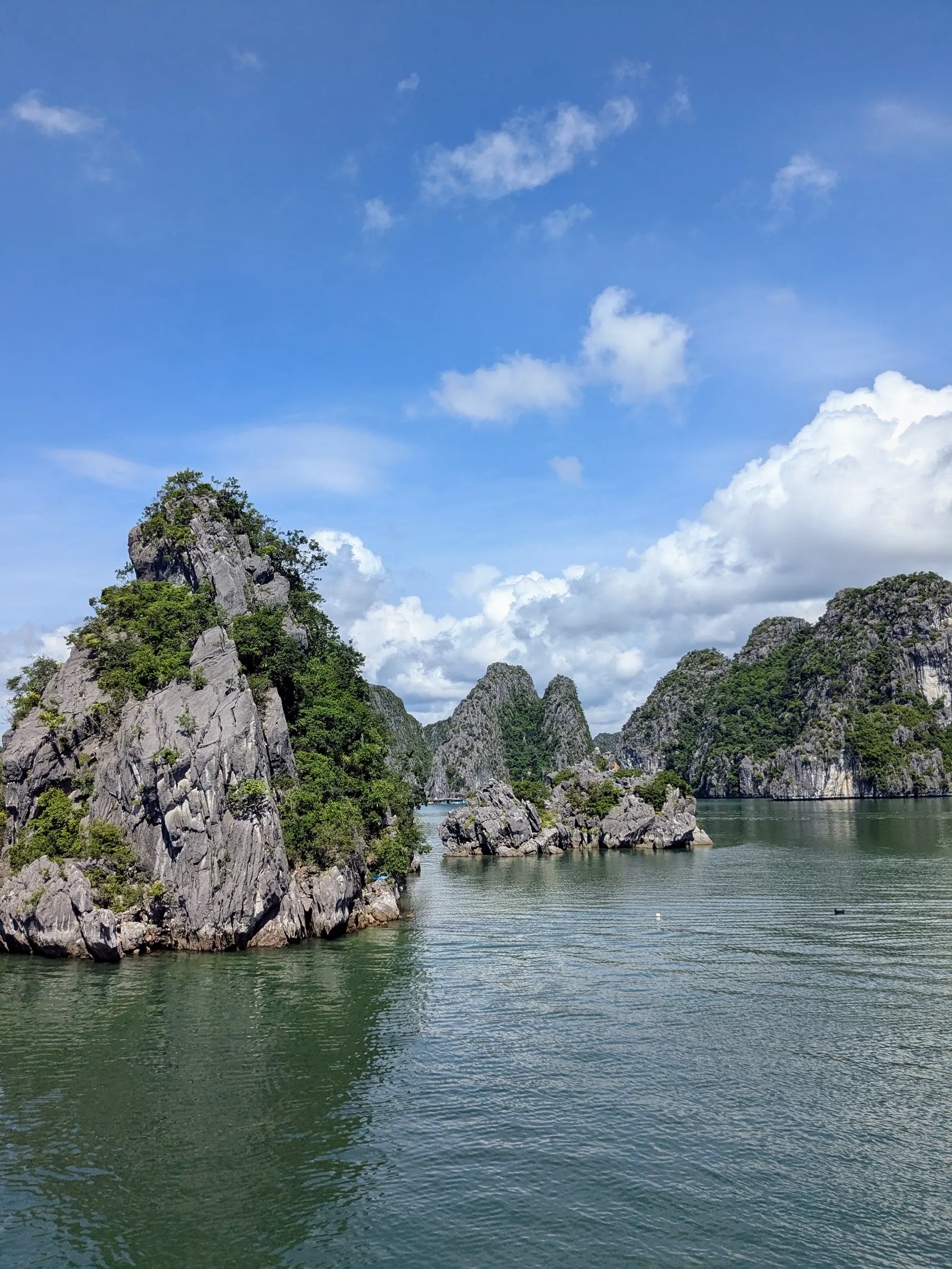 A dramatic channel bordered by steep jungle-topped karst formations in Lan Ha Bay
