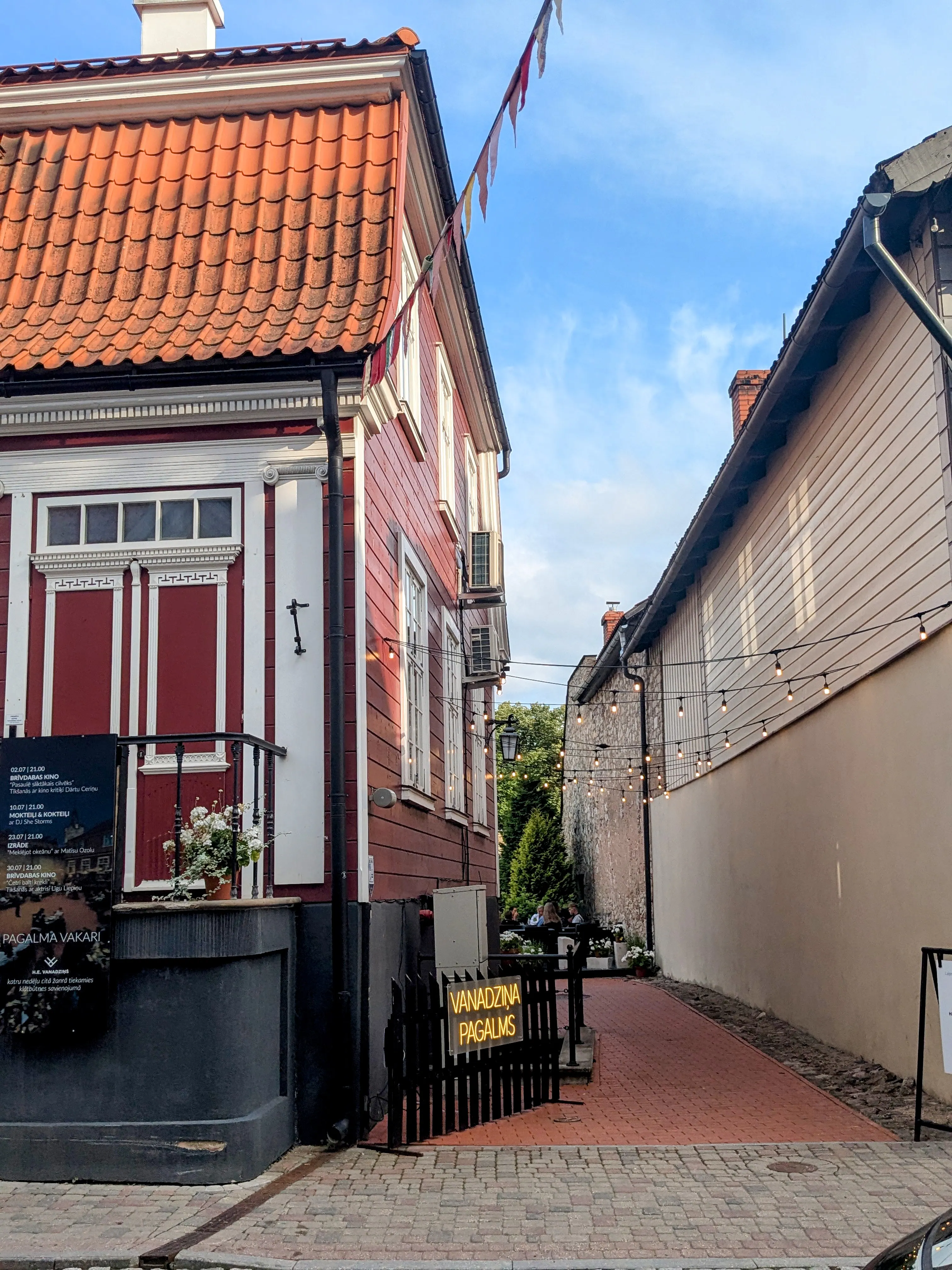 Red and wooden houses along a narrow street in Cēsis