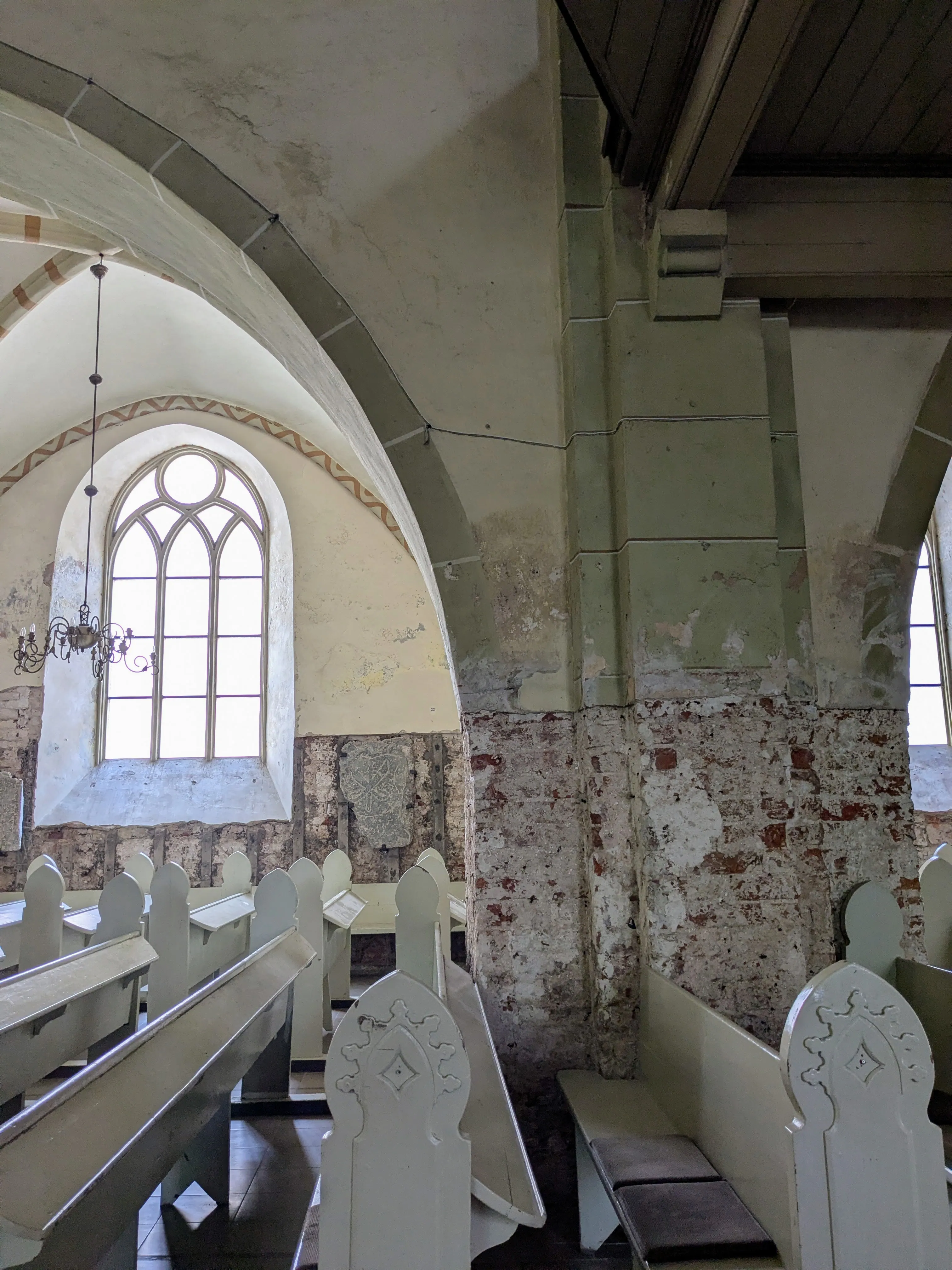 White arches and medieval memorials inside St John’s Church