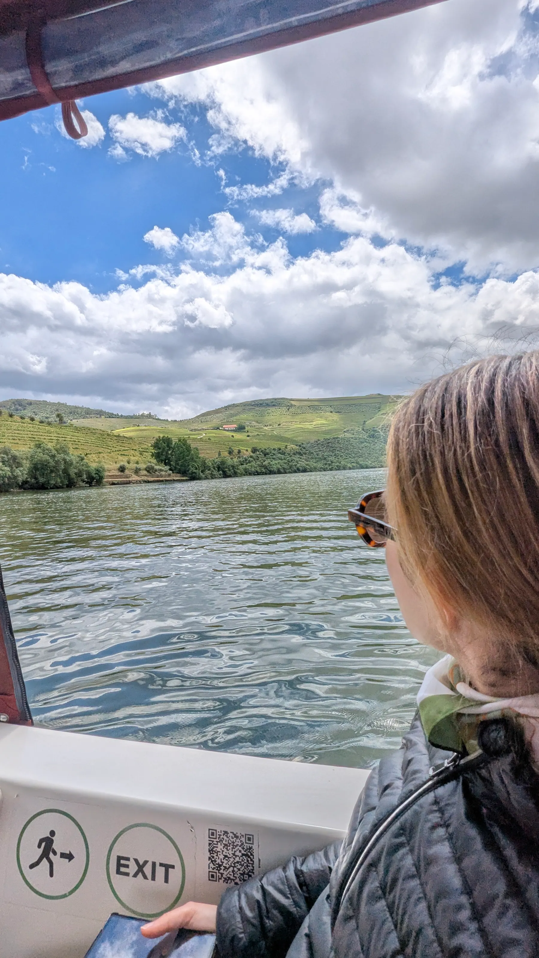 A traveler looking out from a small boat on the Douro River