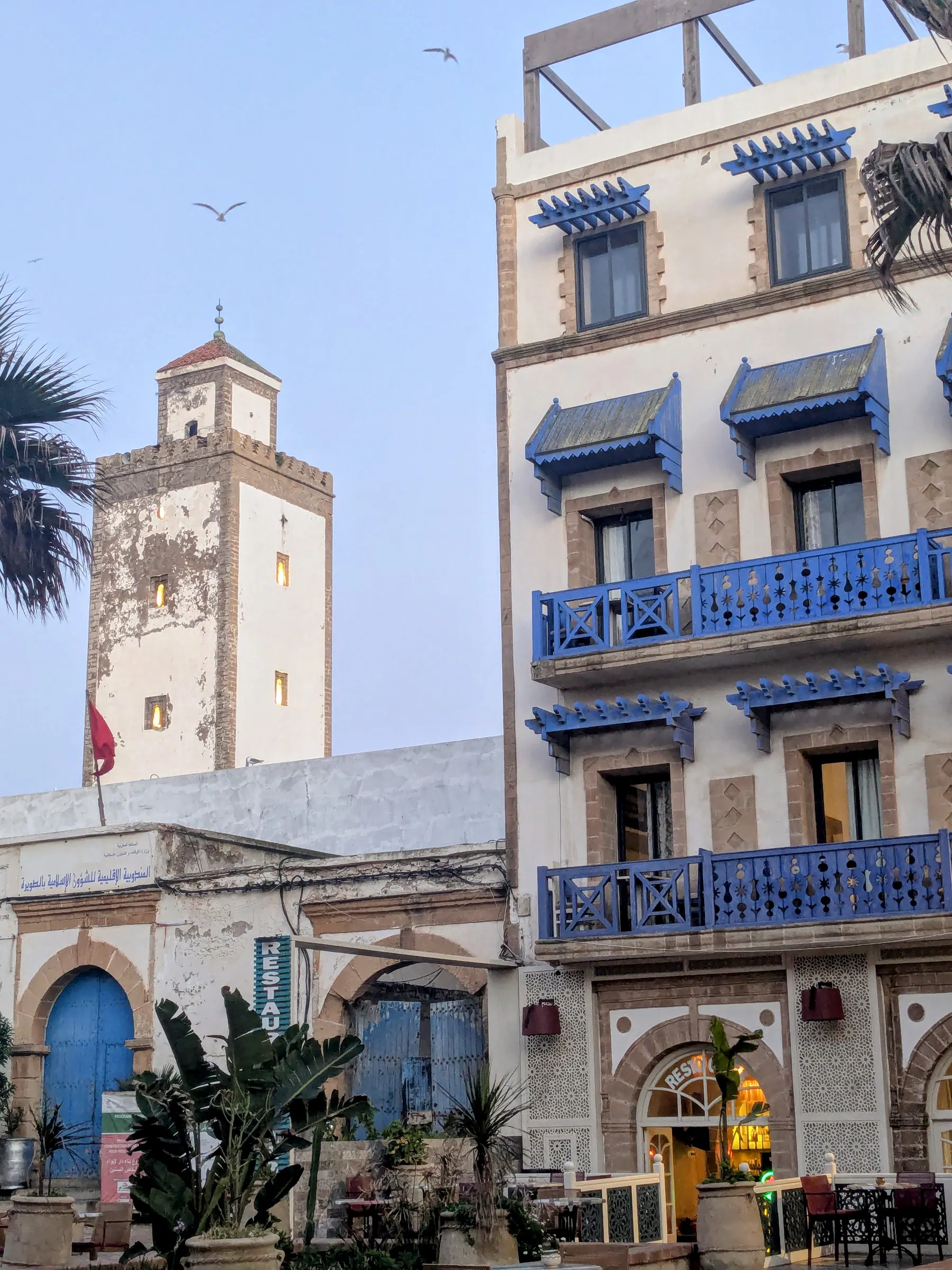 White buildings with blue balconies and a minaret in Essaouira