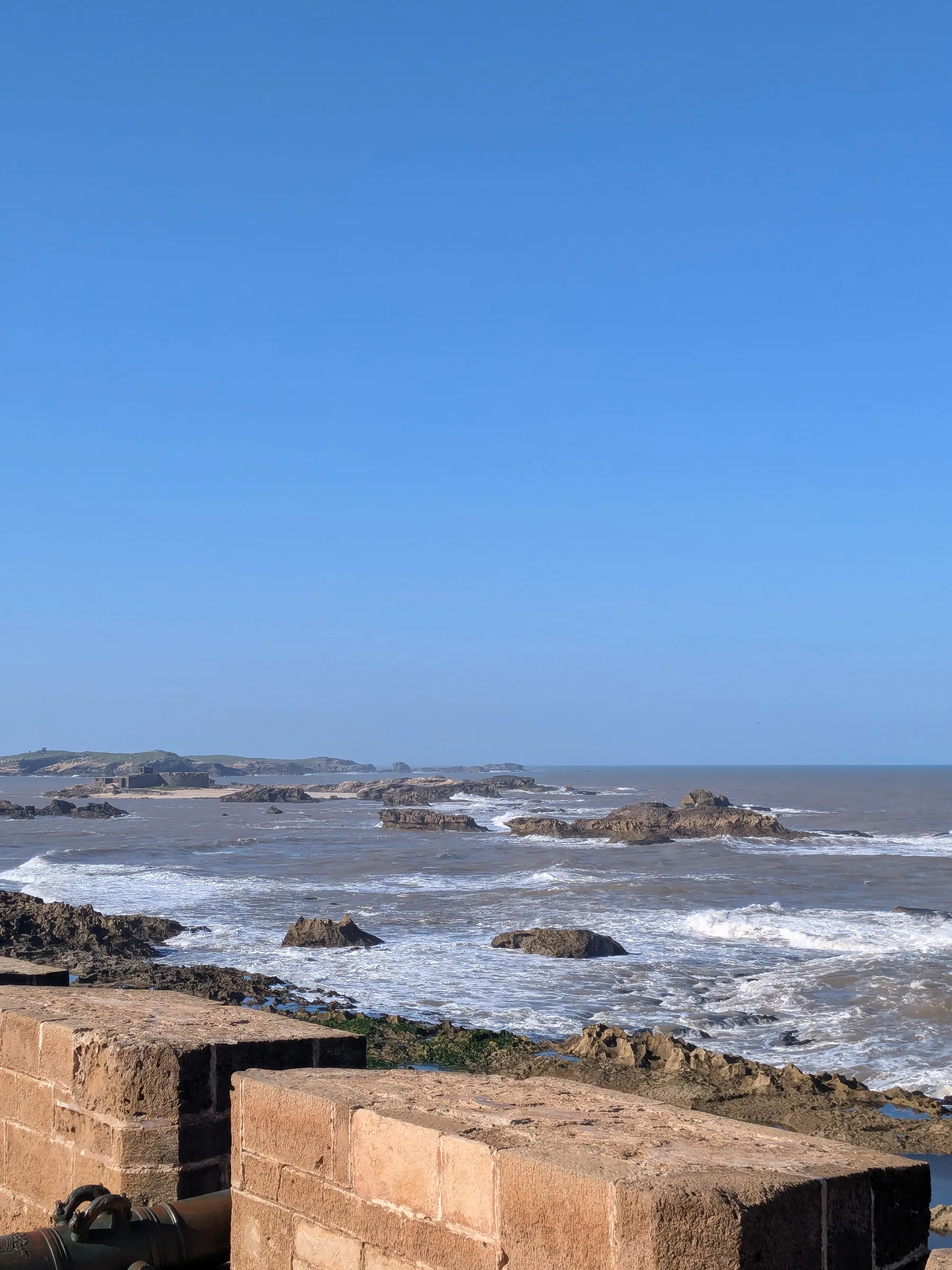 Waves crashing below the stone ramparts of Skala de la Ville in Essaouira