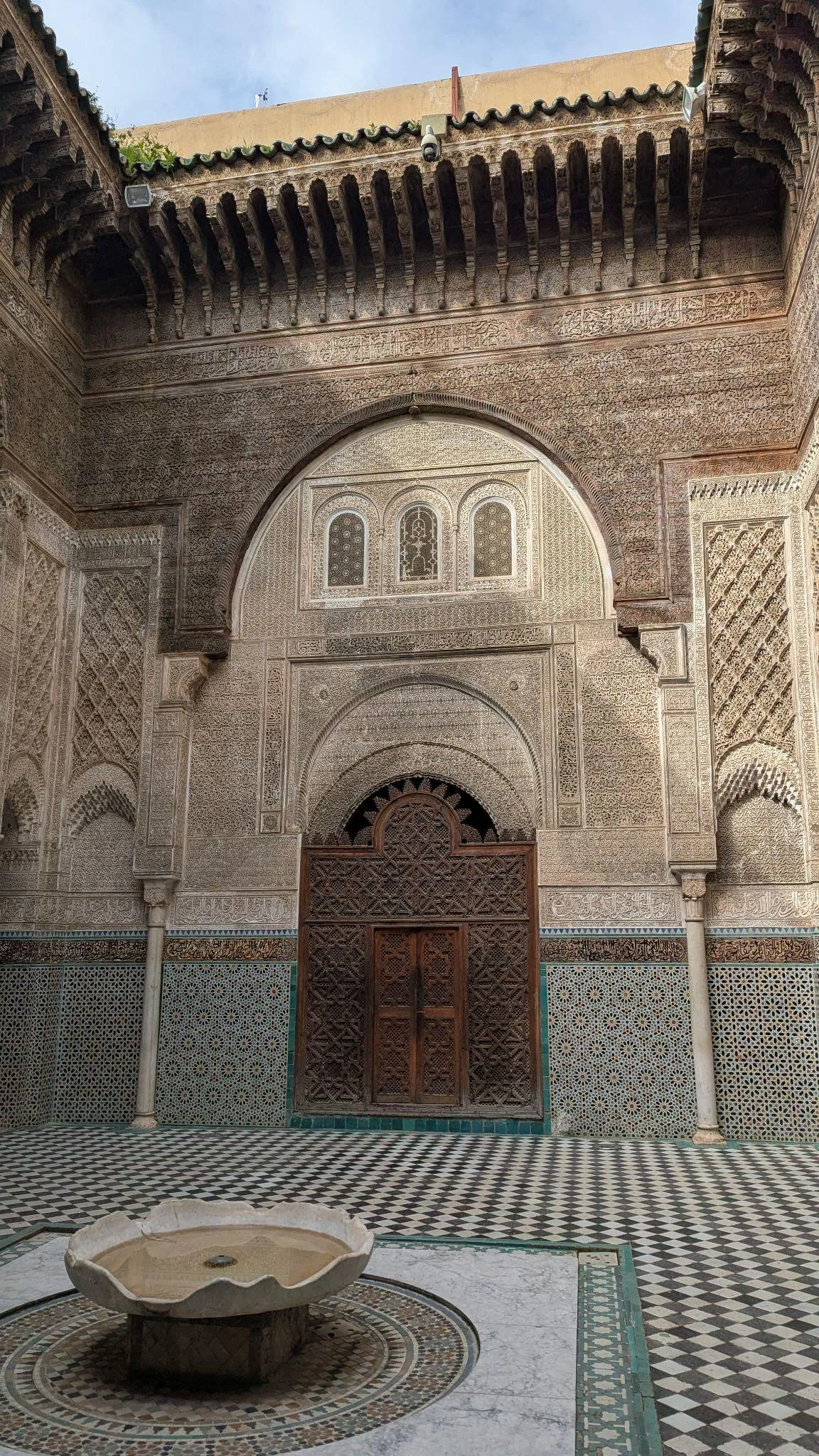 An ornate entrance inside Al Attarine Madrasa in Fez