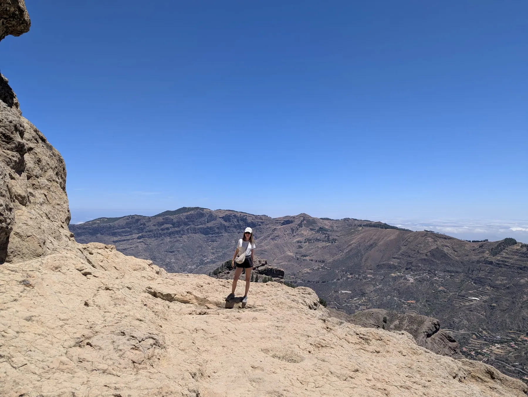 A traveller looking out through a rocky opening across Gran Canariaâ€™s mountains