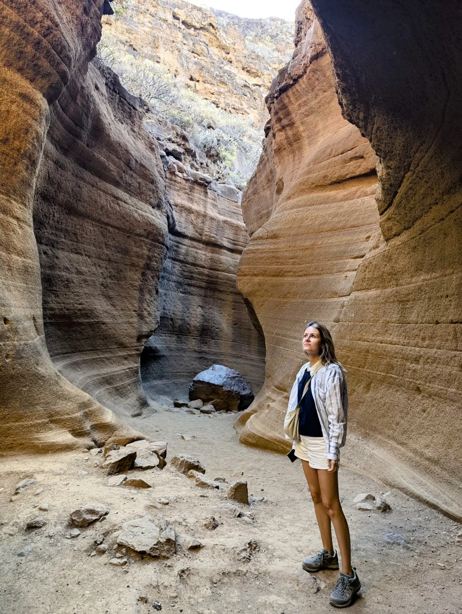 A traveller standing among the narrow layered walls of Barranco de las Vacas