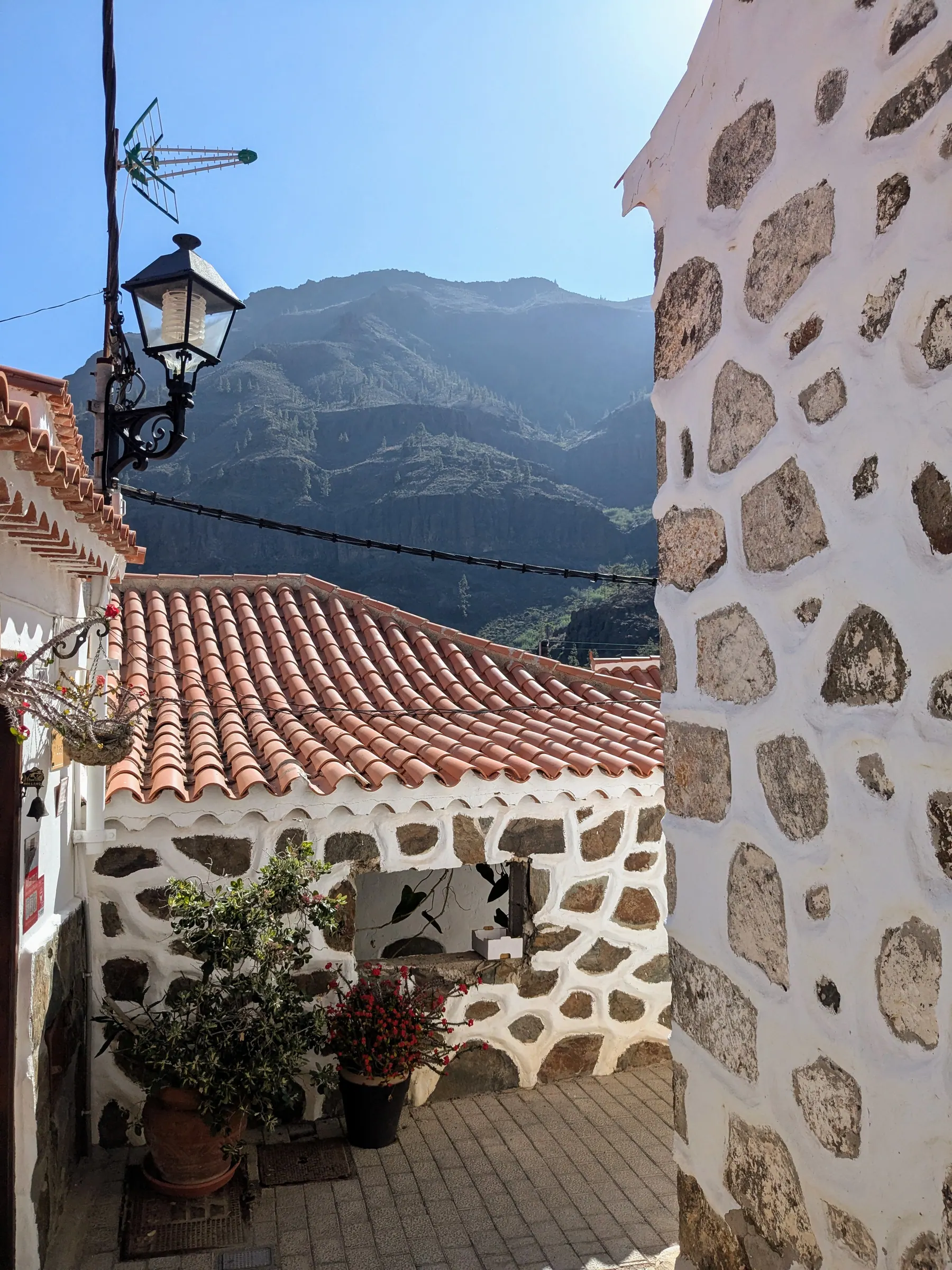 A narrow whitewashed street in the mountain village of Fataga