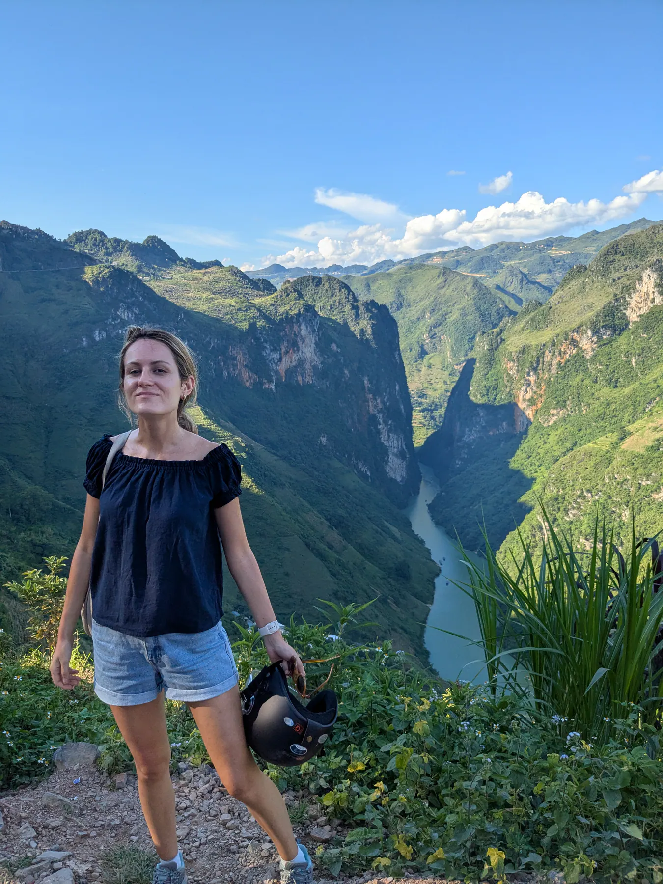 A traveller standing at an overlook with the Nho Que River far below between steep canyon walls