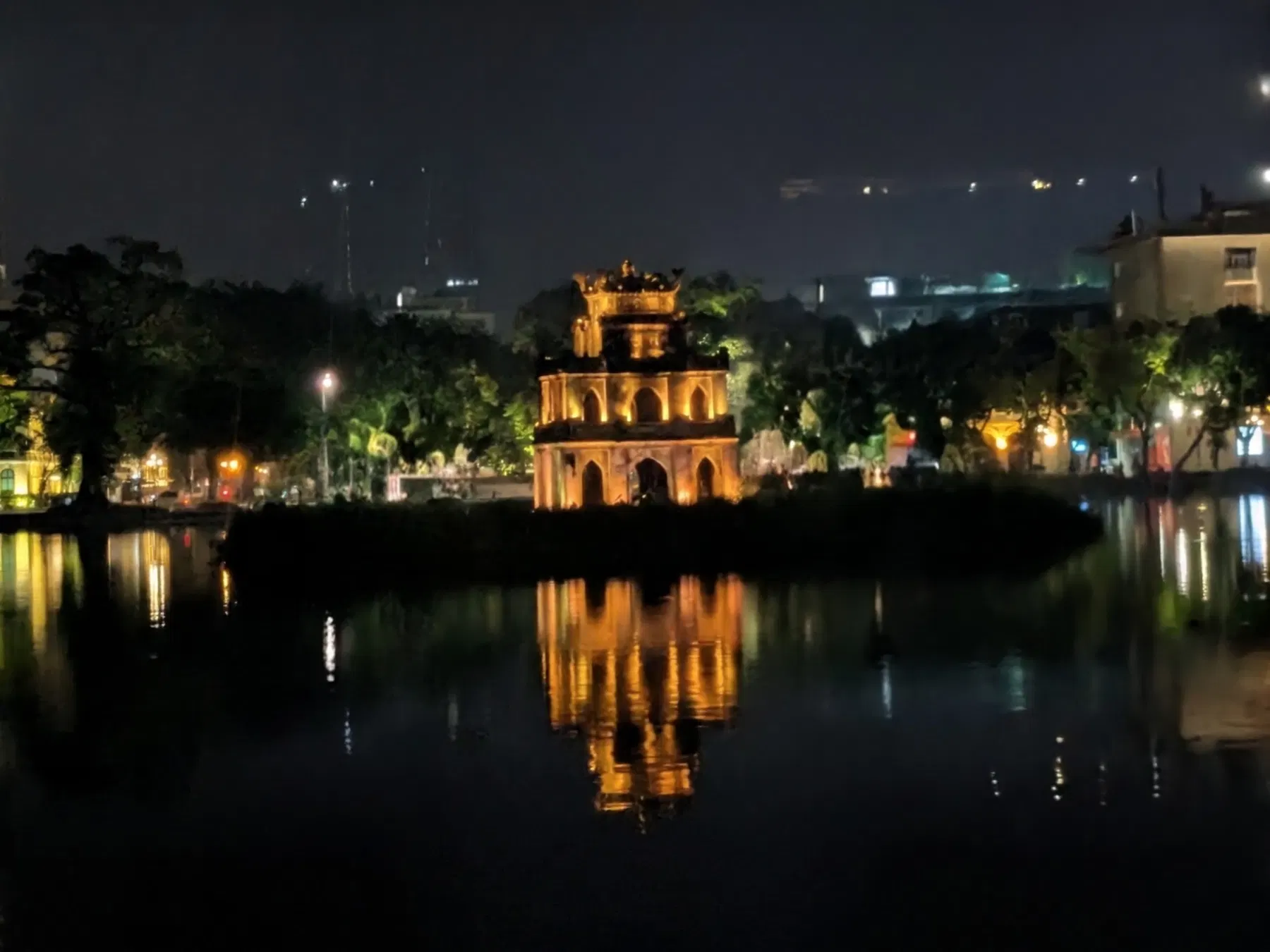 Turtle Tower reflected in the dark water of Hoan Kiem Lake