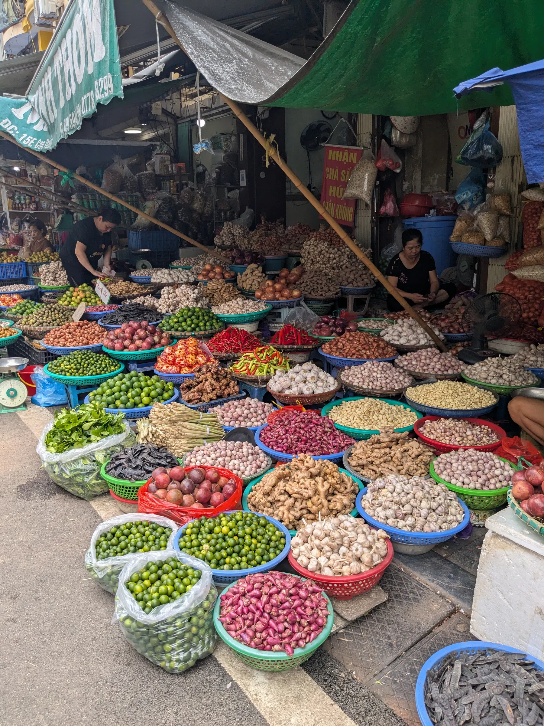 Bowls of colourful fruit and vegetables at a Hanoi market stall