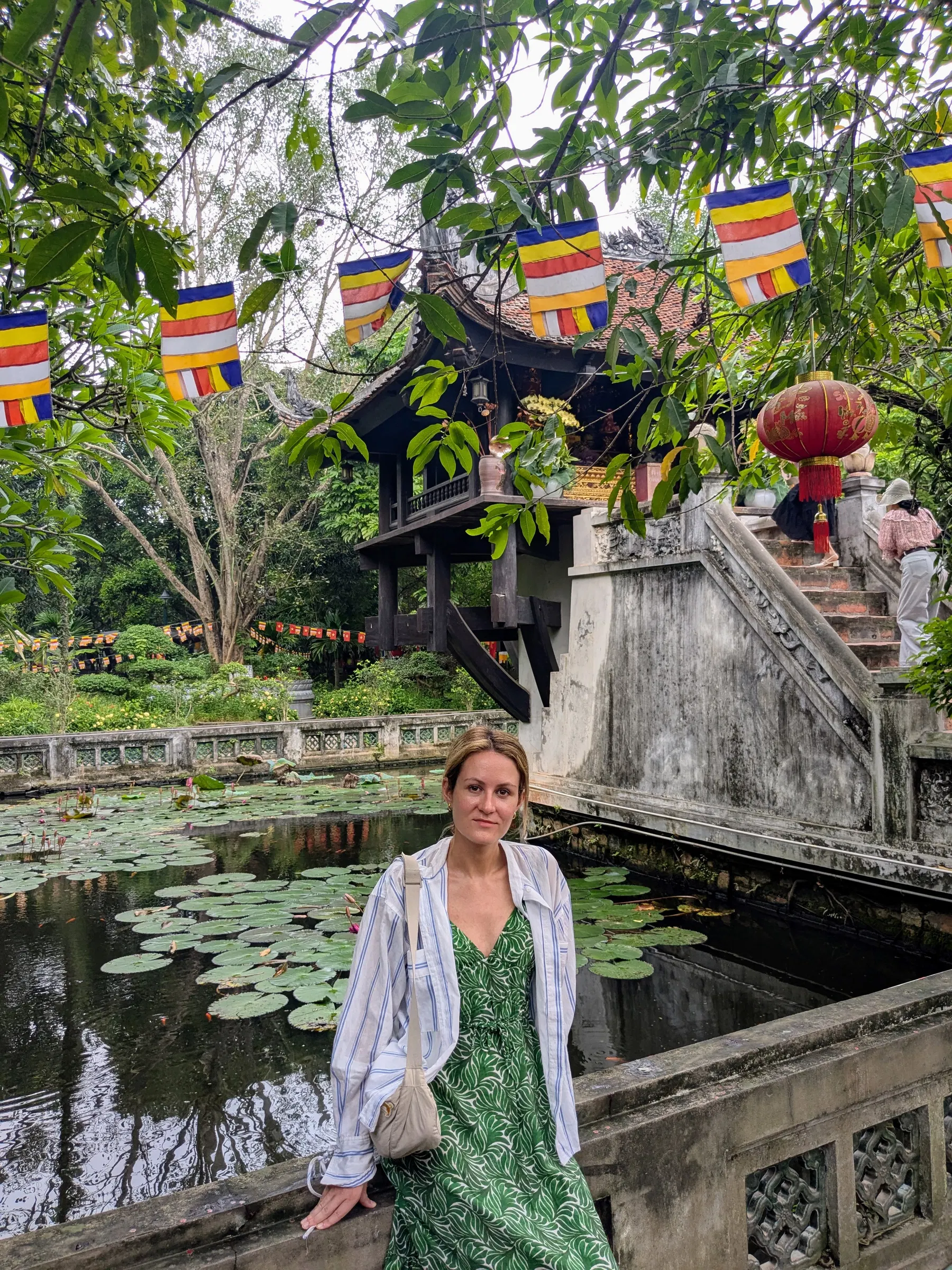 A traveller beside the lotus pond and wooden One Pillar Pagoda