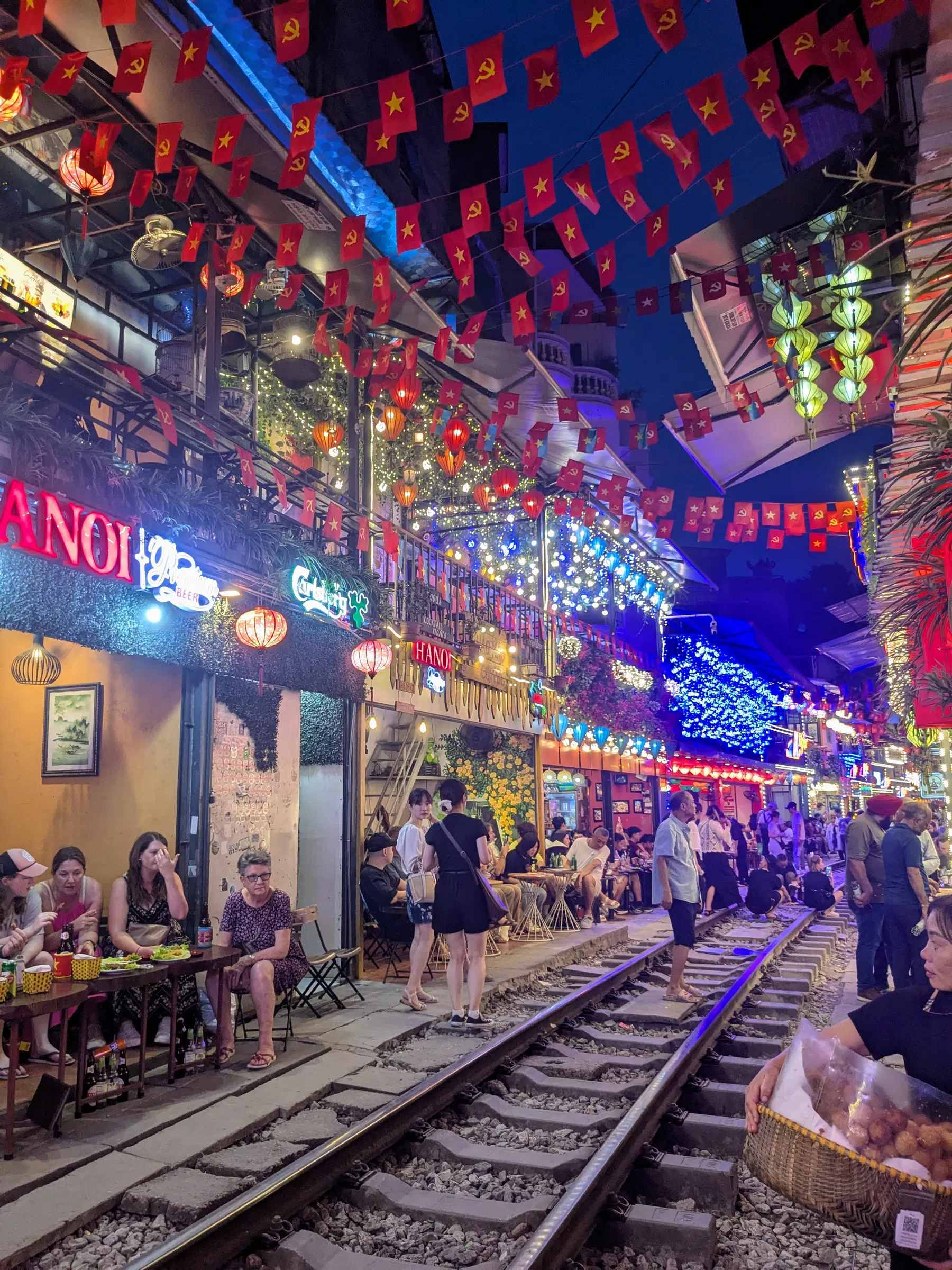 A café beside the tracks on Hanoi Train Street at night