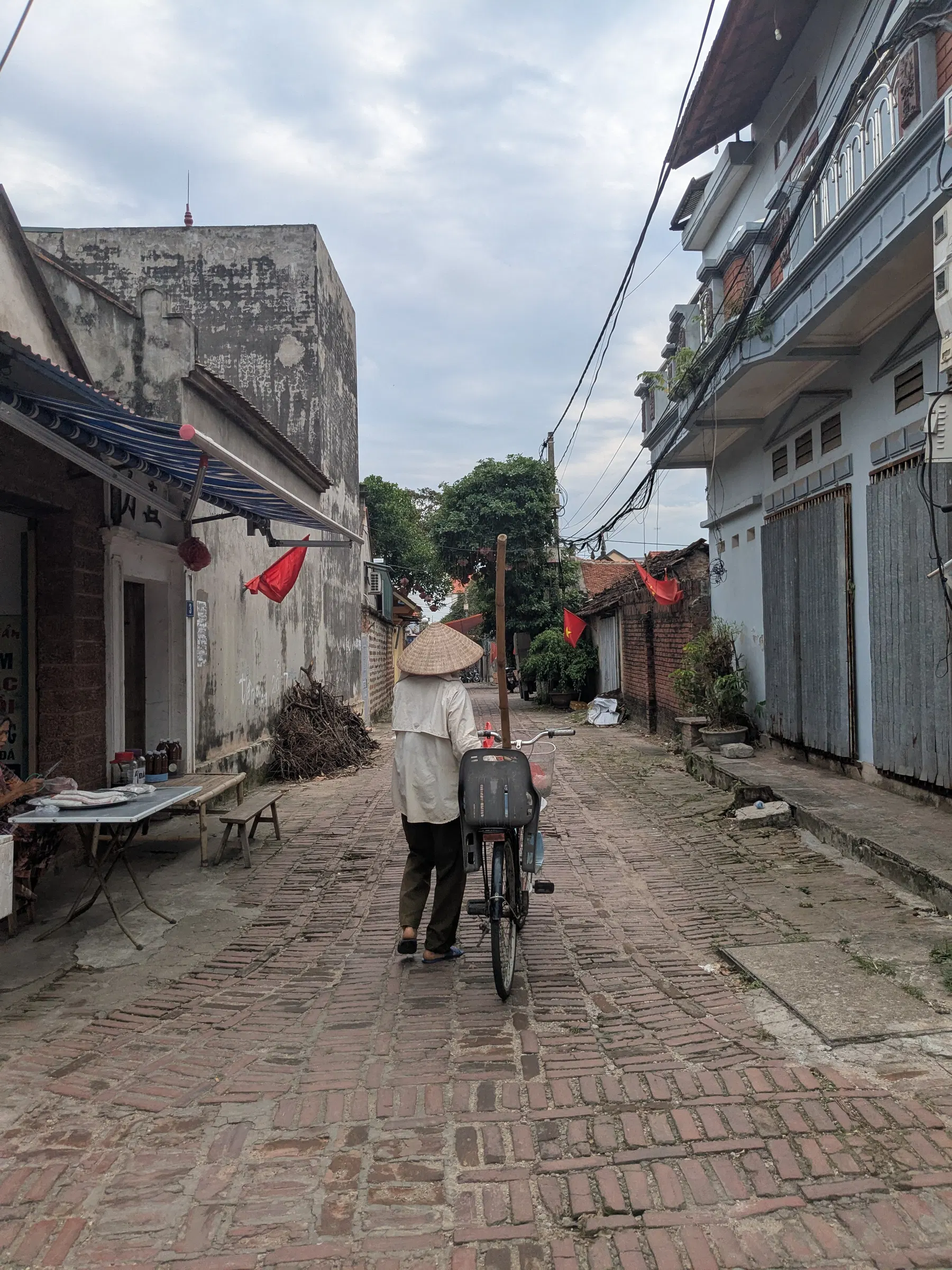 A quiet brick lane and traditional houses in Đường Lâm village