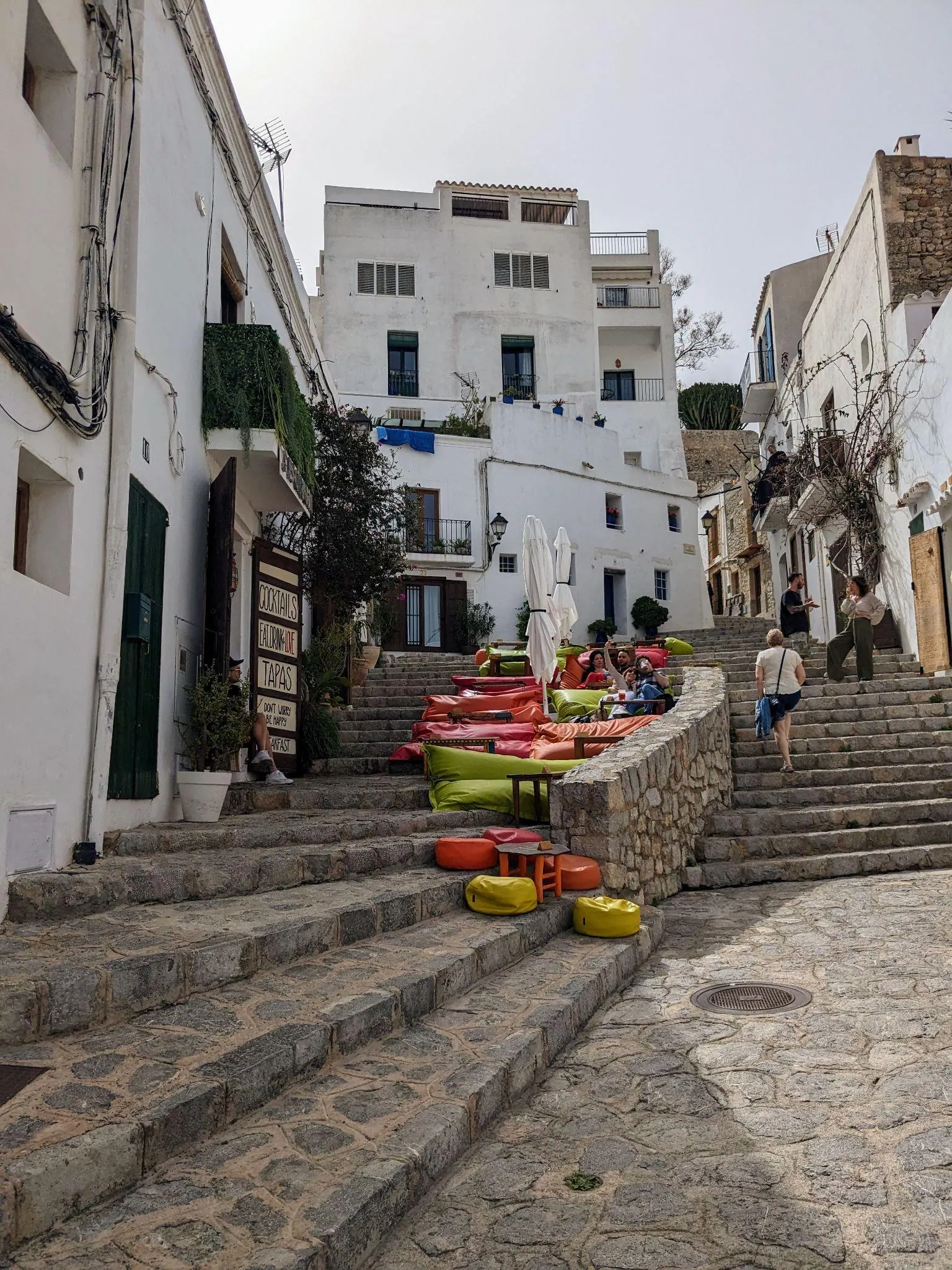 Quiet cobblestone street with whitewashed houses in the historic centre of Dalt Vila