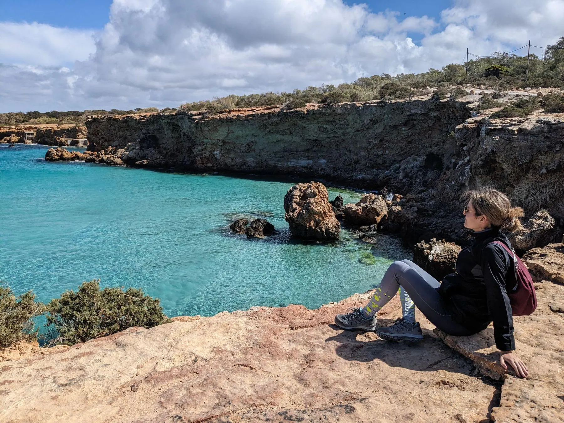 Rocky shoreline and turquoise sea along the hike between Cala Comte and Cala Bassa