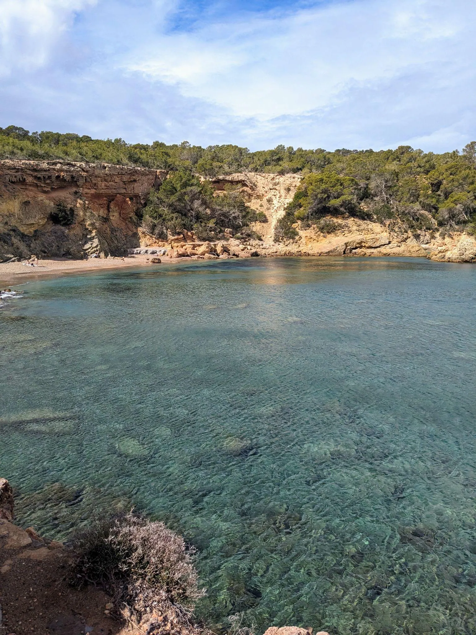 Steep rocky bluffs and deep blue water at Cala Xarraca in northern Ibiza