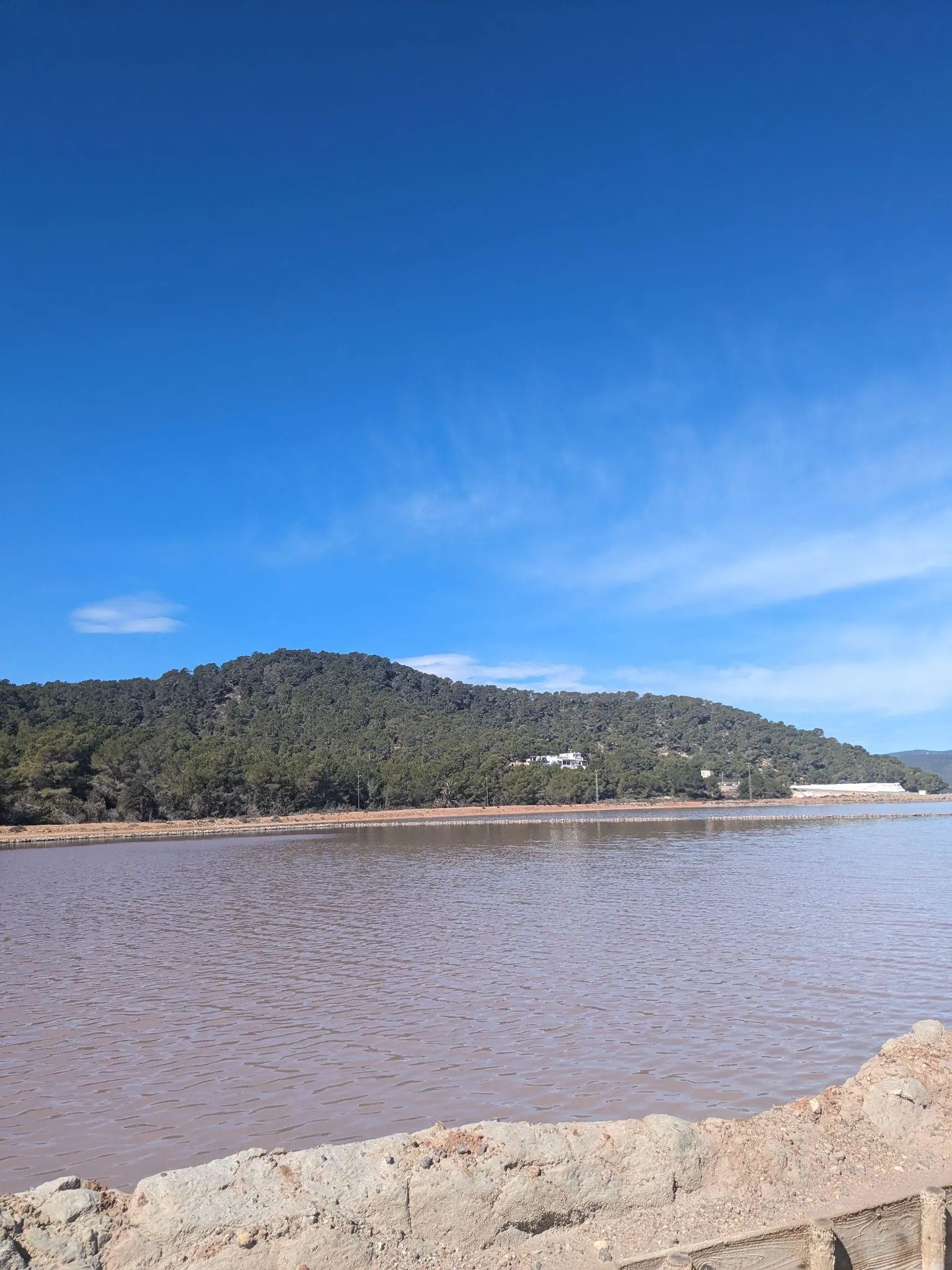 Still reflective waters of the shallow salt pans in Parc Natural de Ses Salines