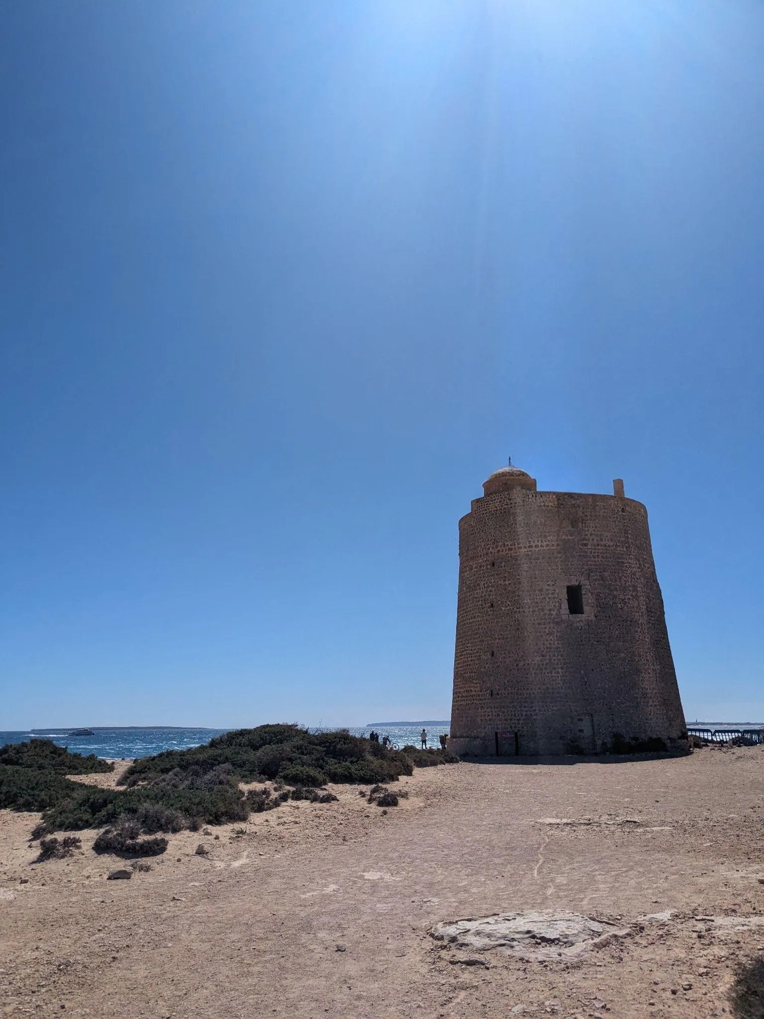 Historic stone watchtower Torre de Ses Portes standing on the southern headland