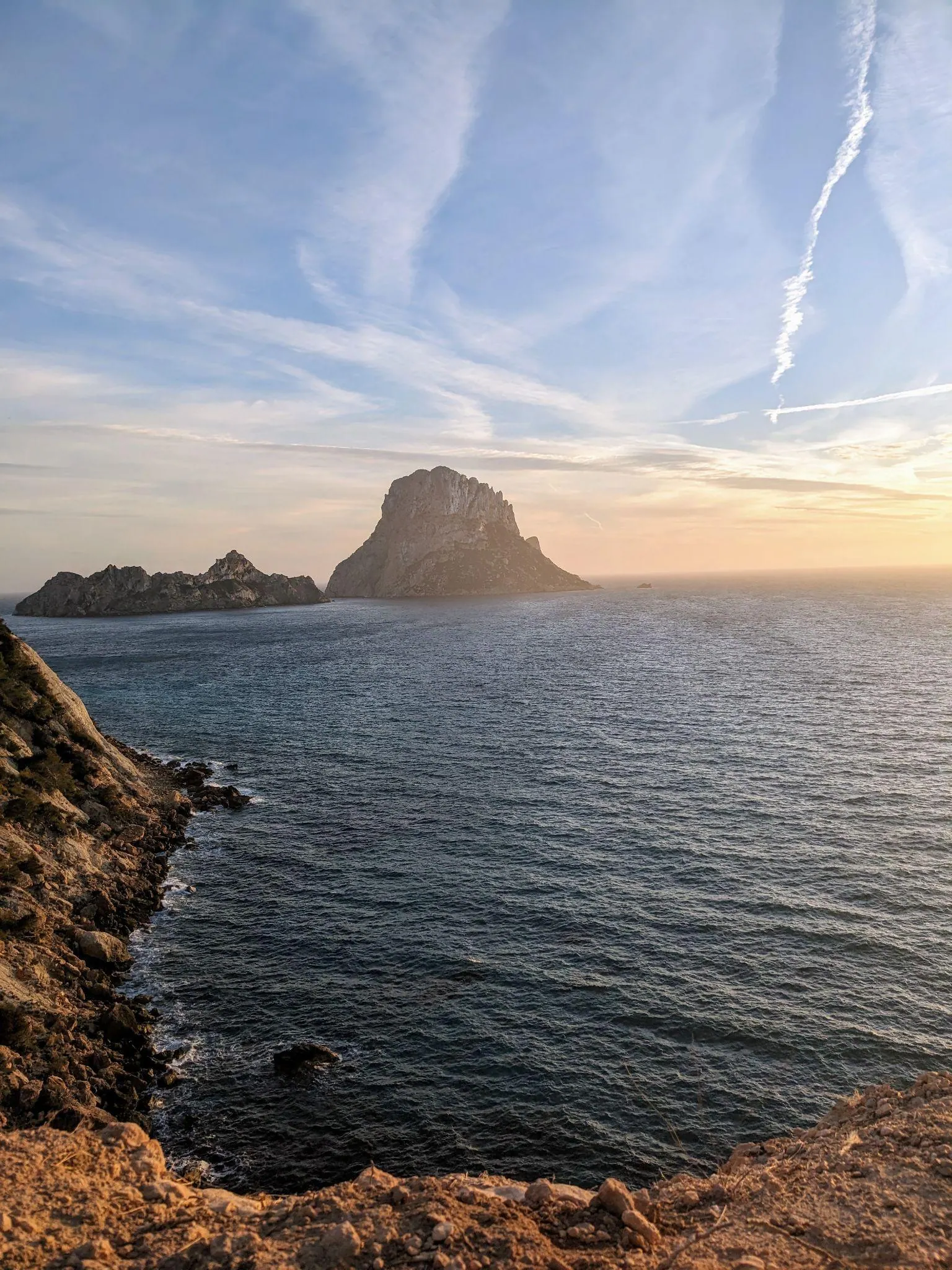 The steep limestone cliffs of Es Vedrà rising directly from the Mediterranean Sea