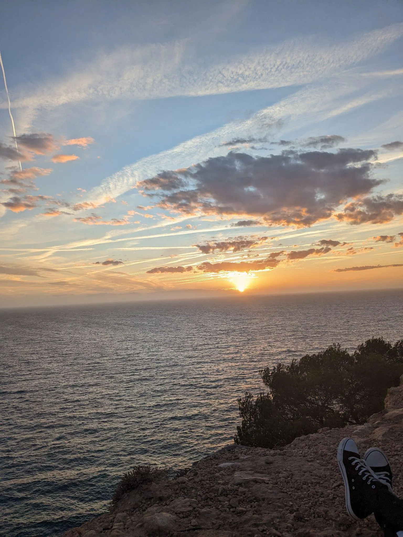 High cliff viewpoint overlooking the sea and the island of Es Vedrà in afternoon light