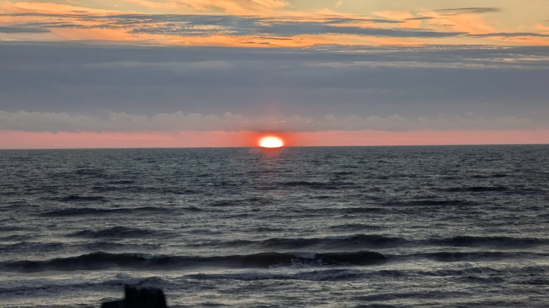 The orange sun sinking into the Baltic Sea at Jūrkalne