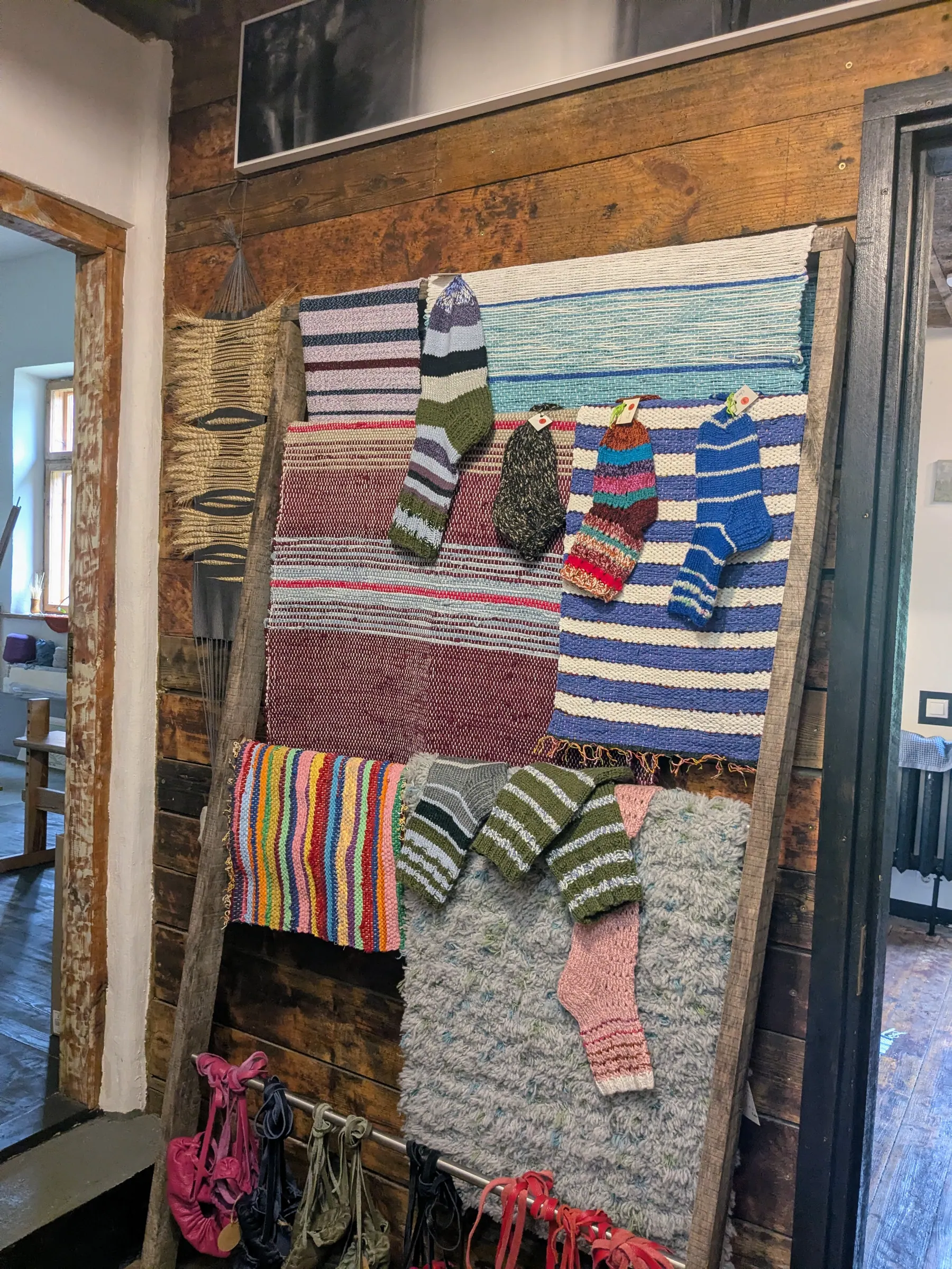Colourful woven artworks displayed inside a Pāvilosta exhibition