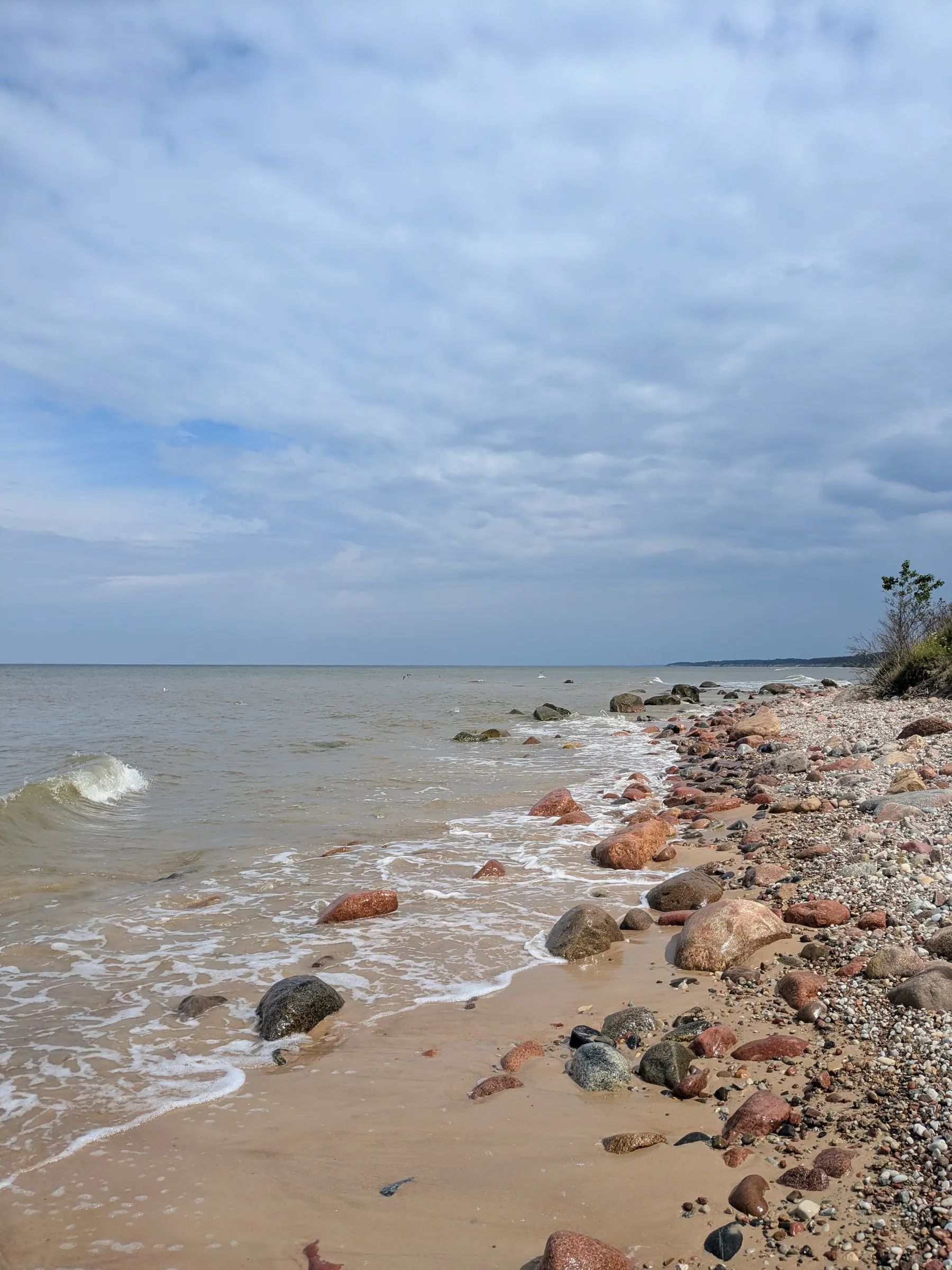 A beach covered in colourful Baltic stones near Pāvilosta