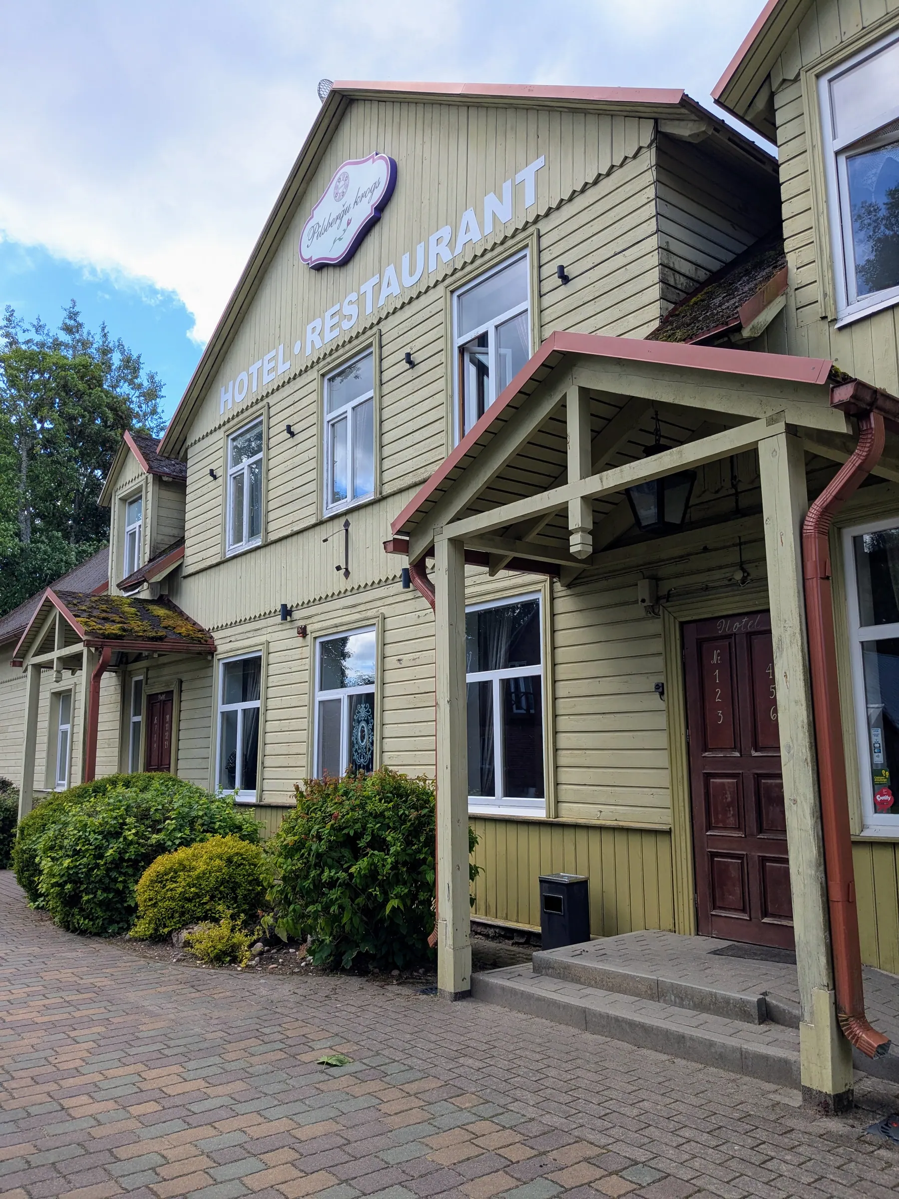 The historic wooden exterior of Pilsberģu krogs in Jūrkalne