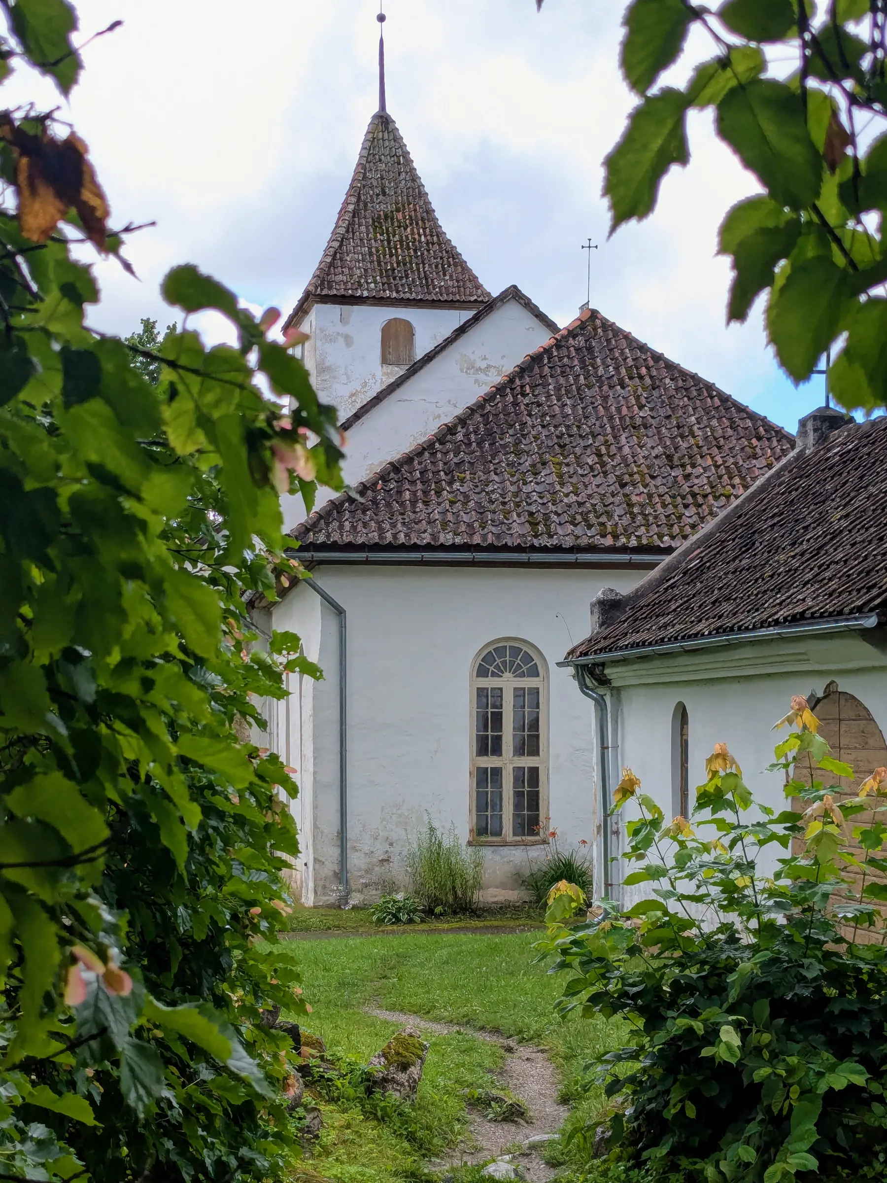 Sabile Evangelical Lutheran Church framed by leafy branches