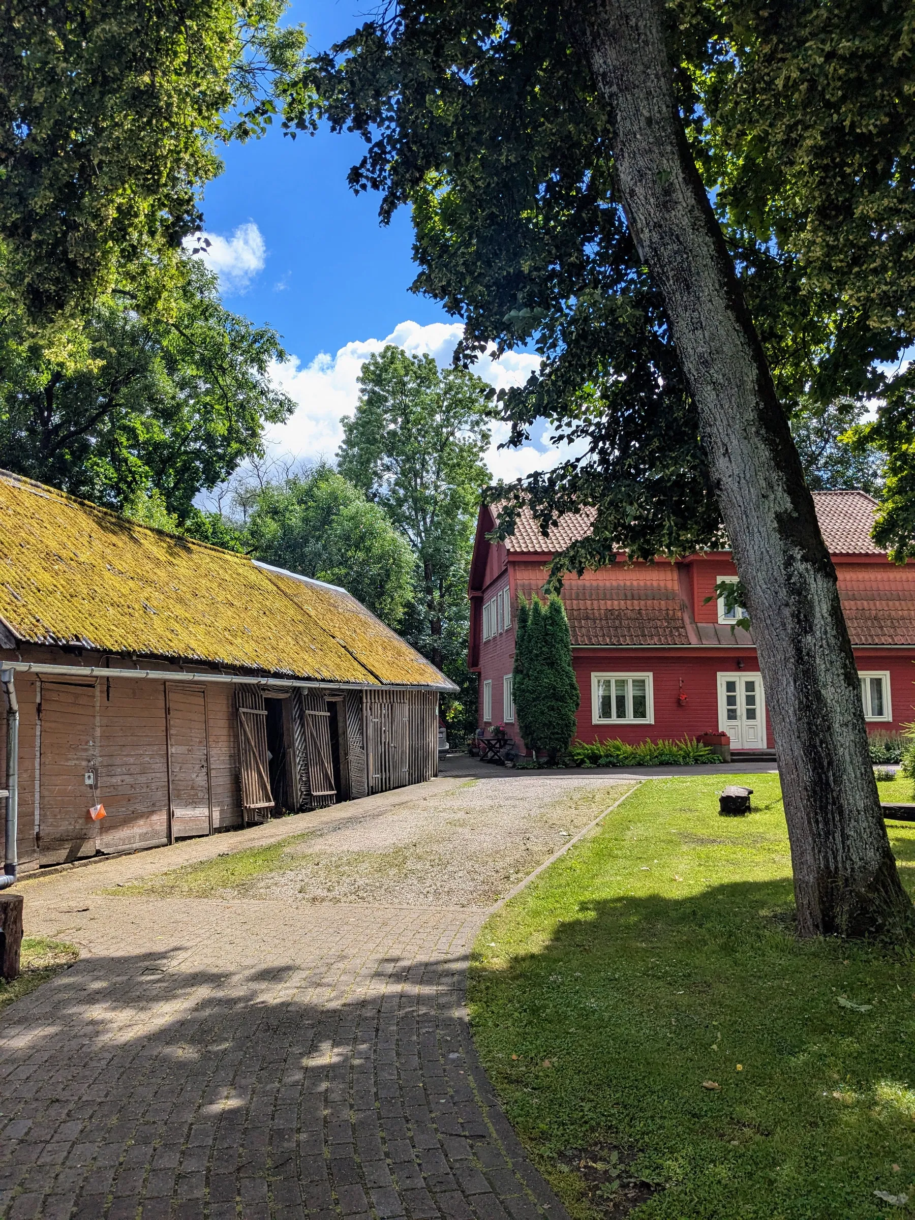 Wooden heritage sheds and a red house in Kuldīga