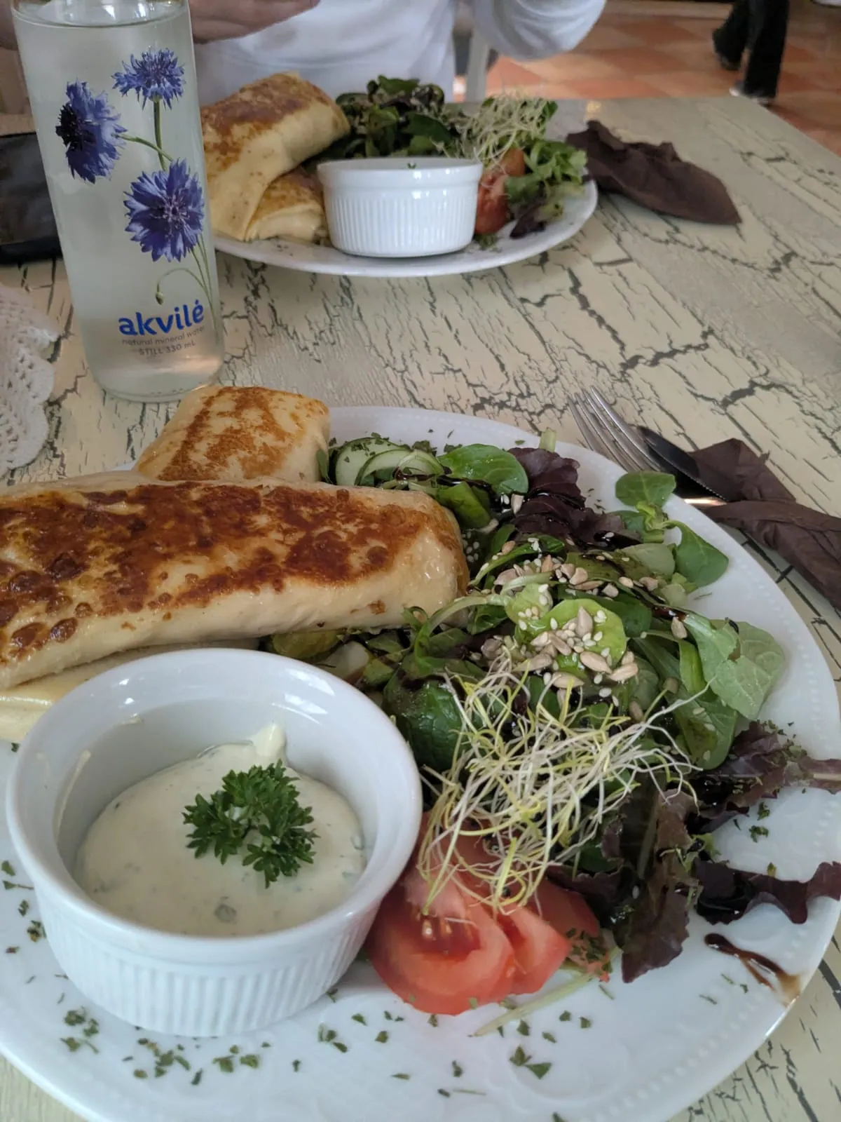 Cheese and ham pancakes served with salad at Marmelāde in Kuldīga