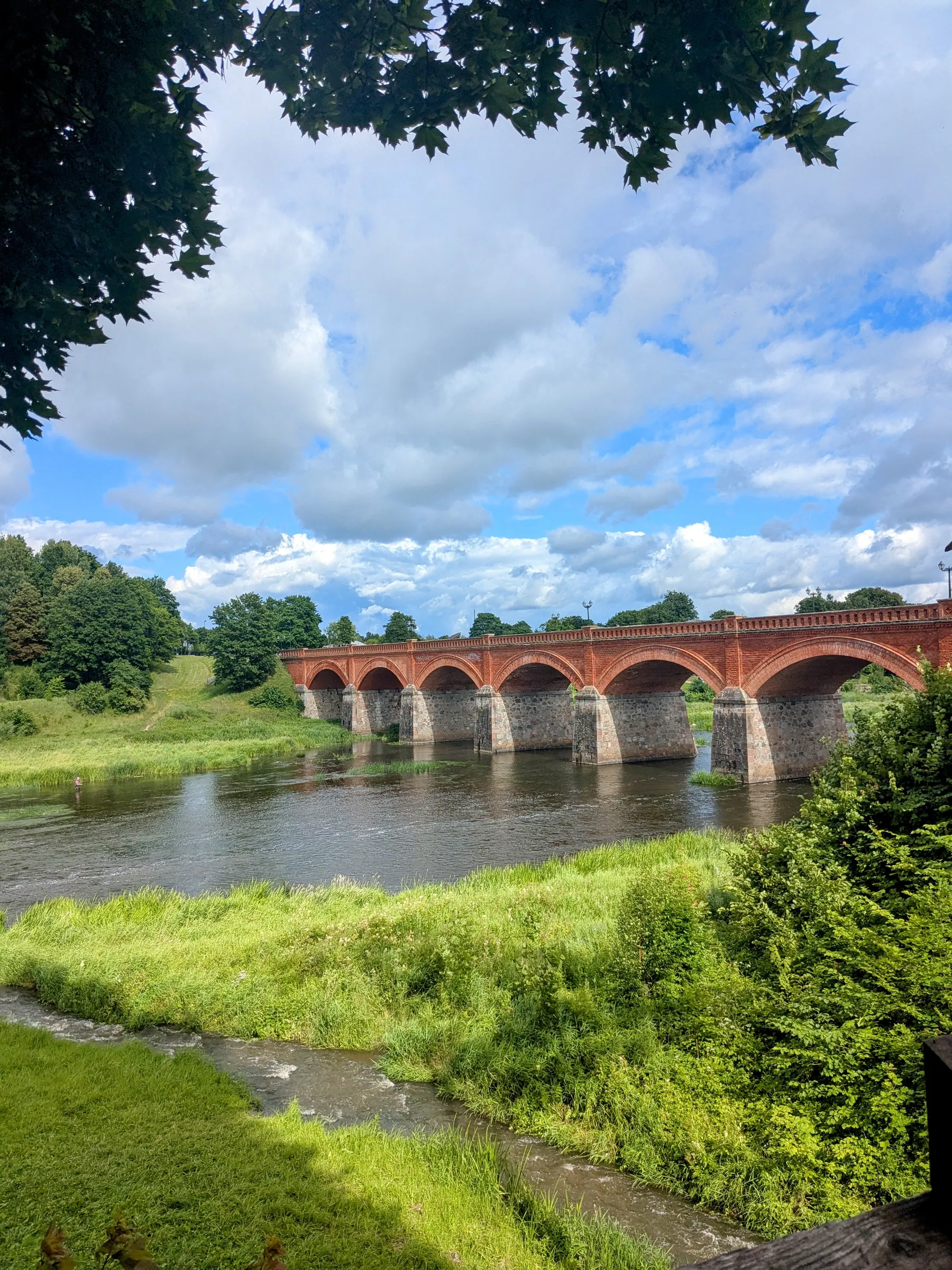 Historic red-brick bridge crossing the Venta River in Kuldīga