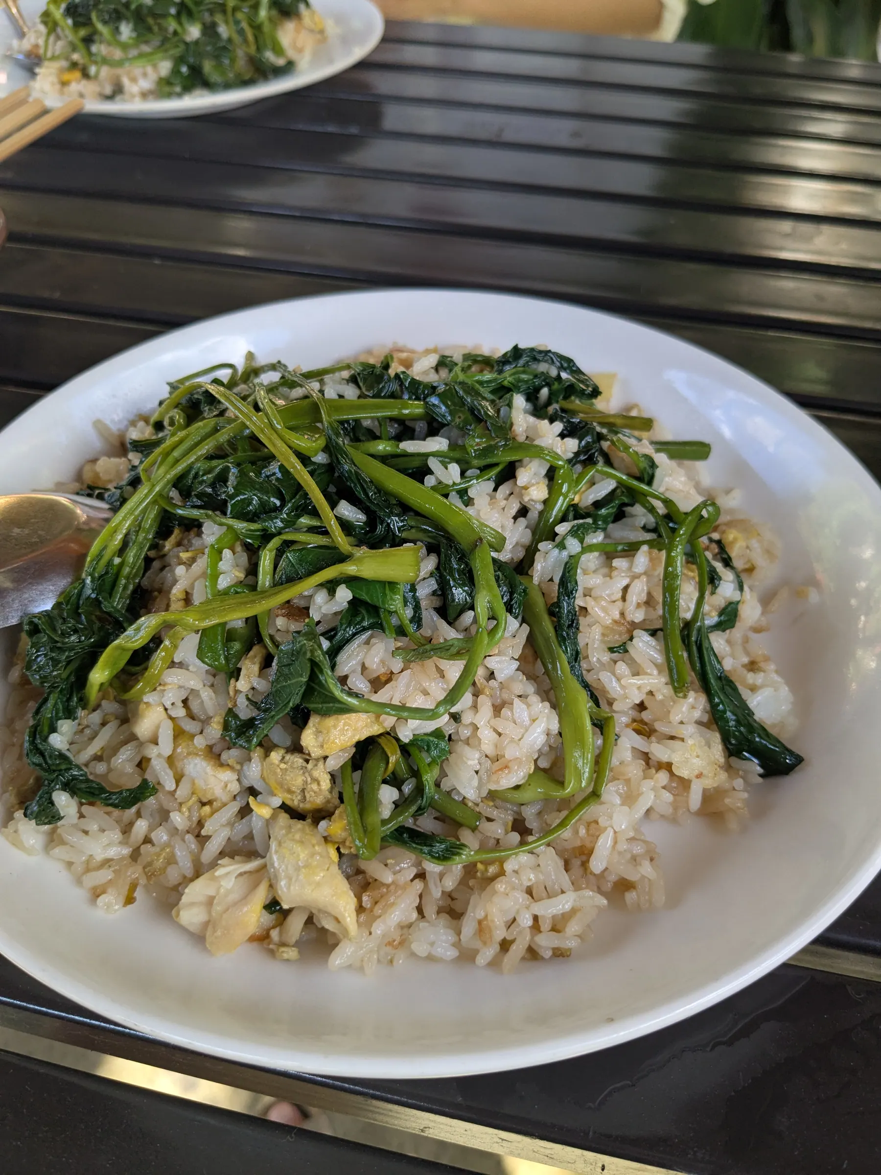 A plate of crispy chicken and greens at a Mai Chau restaurant