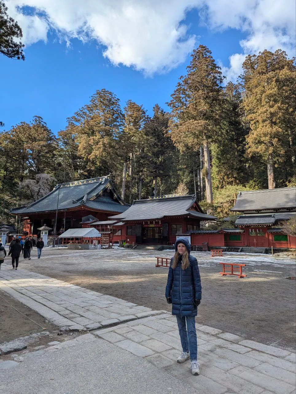 A Nikko temple courtyard with red buildings and snow