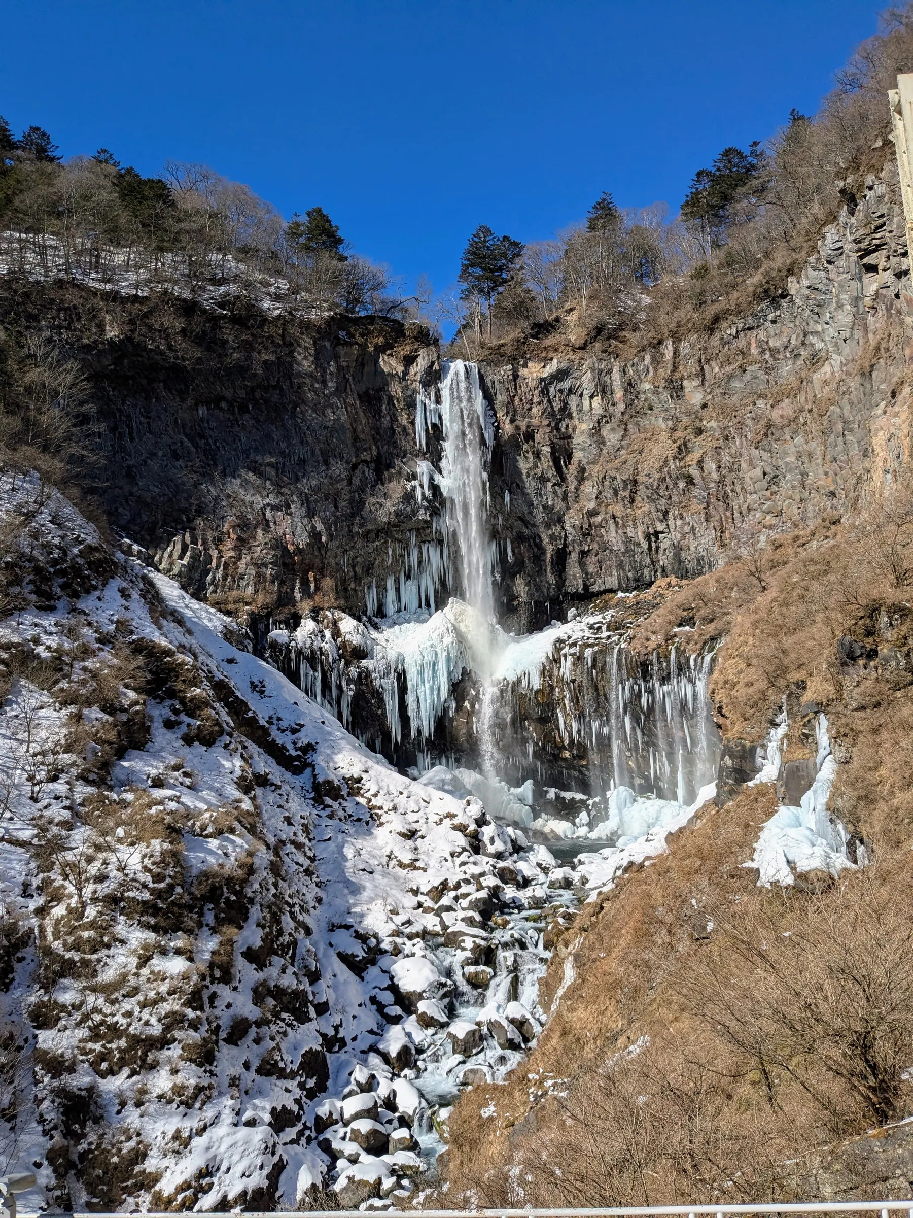 Snowy rocks and water below Kegon Falls