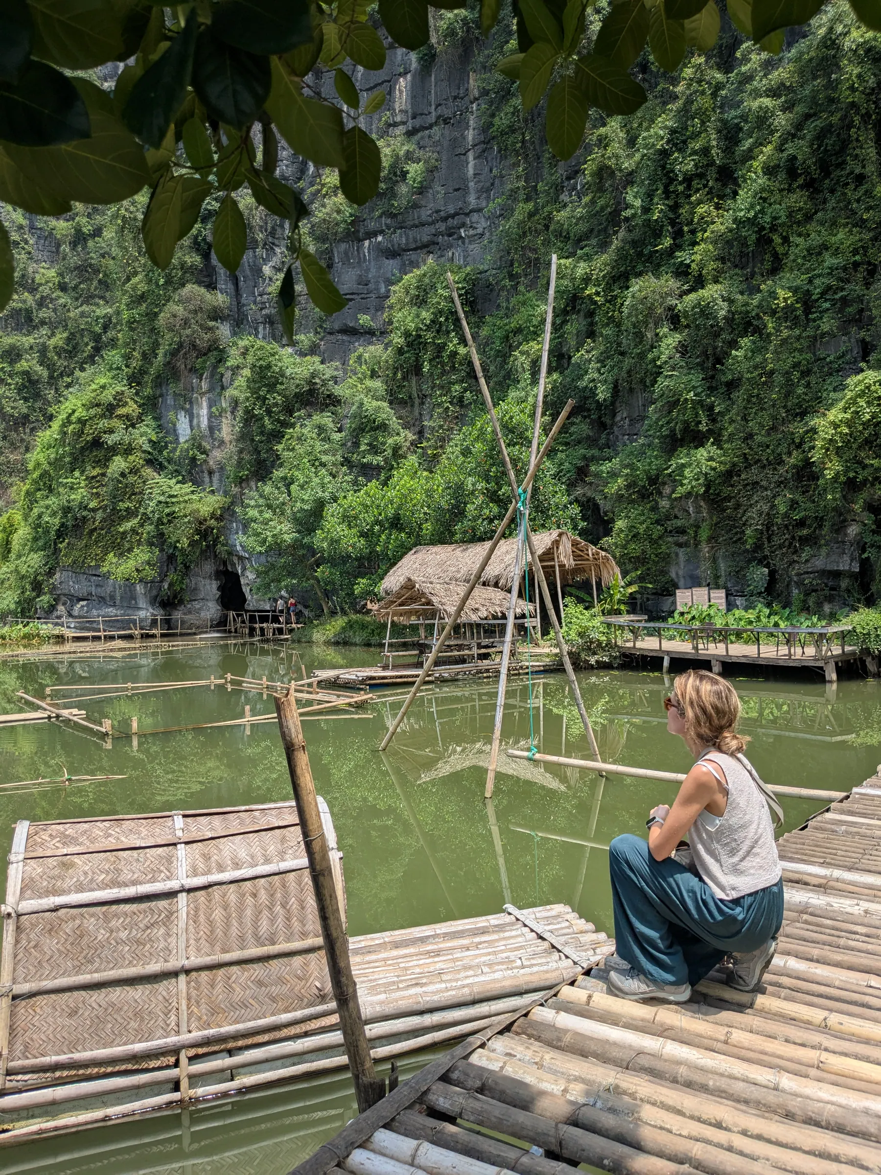 A traveller on a wooden platform beside water at Buffalo Cave