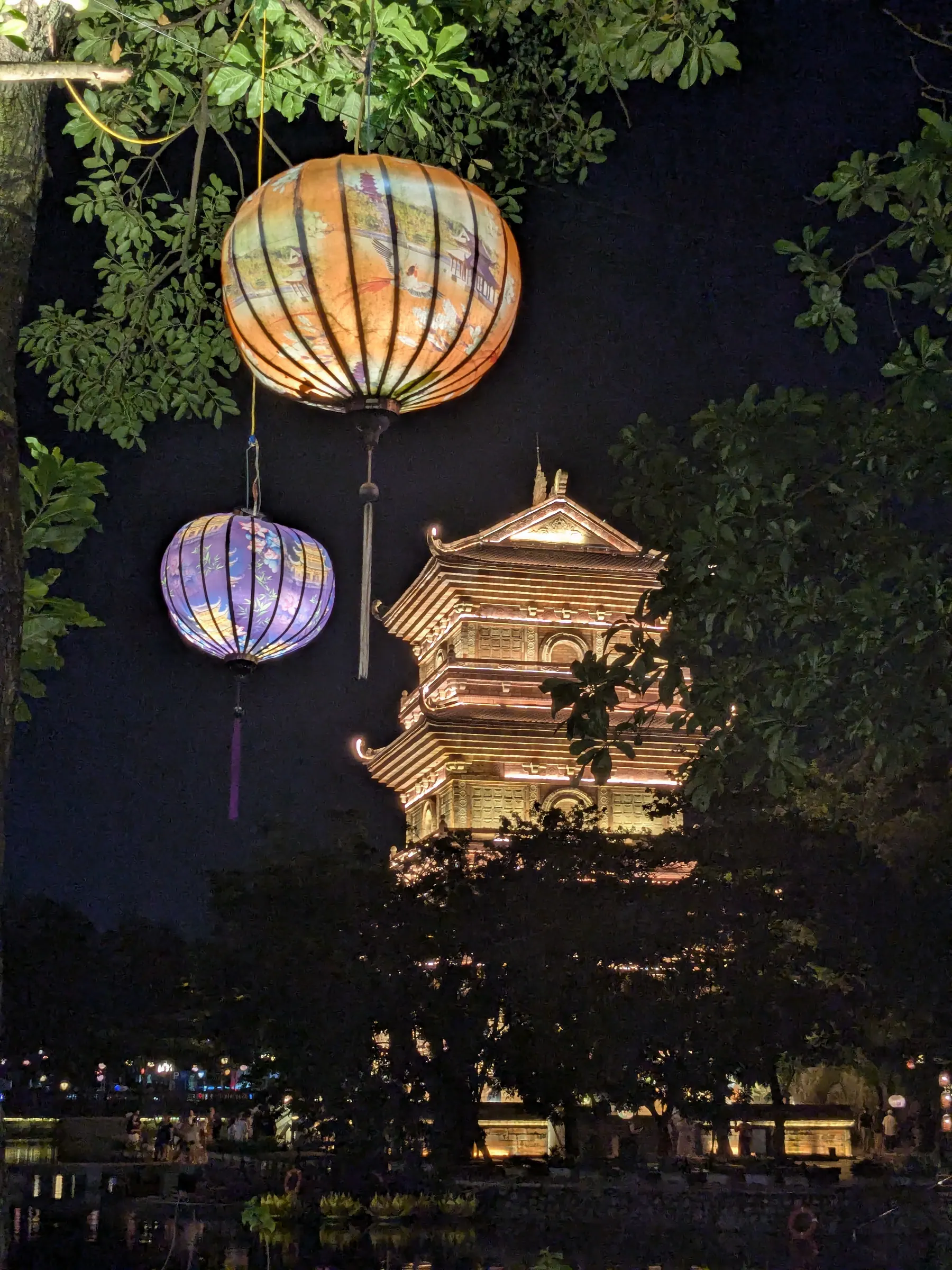 A pagoda reflected in the lake at Ninh Binh old town after dark