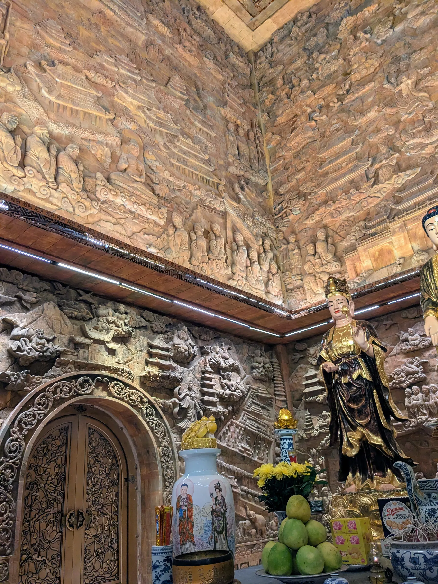 Carved statues and offerings inside a richly decorated temple