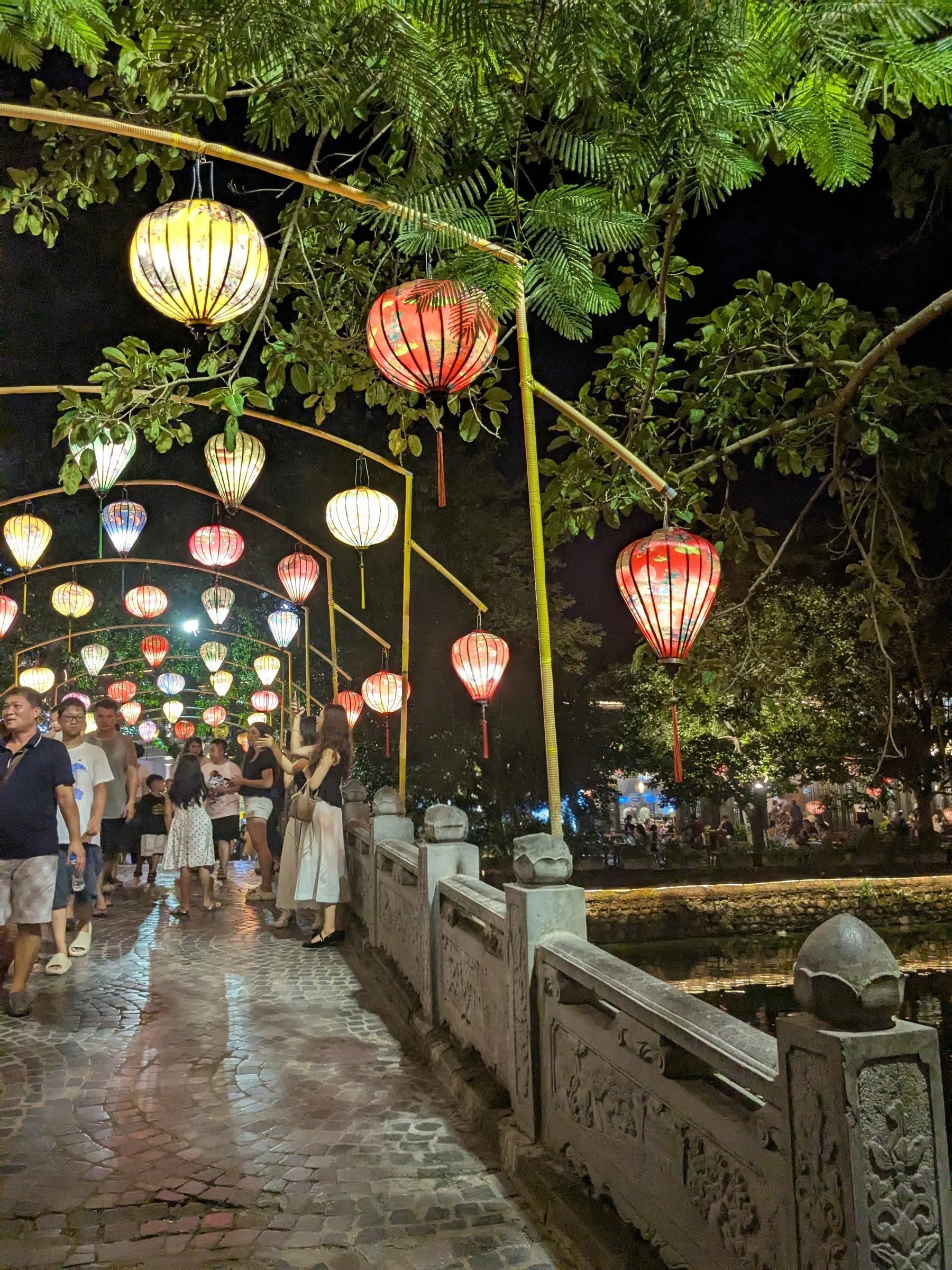 Colourful lantern displays beside the water at night