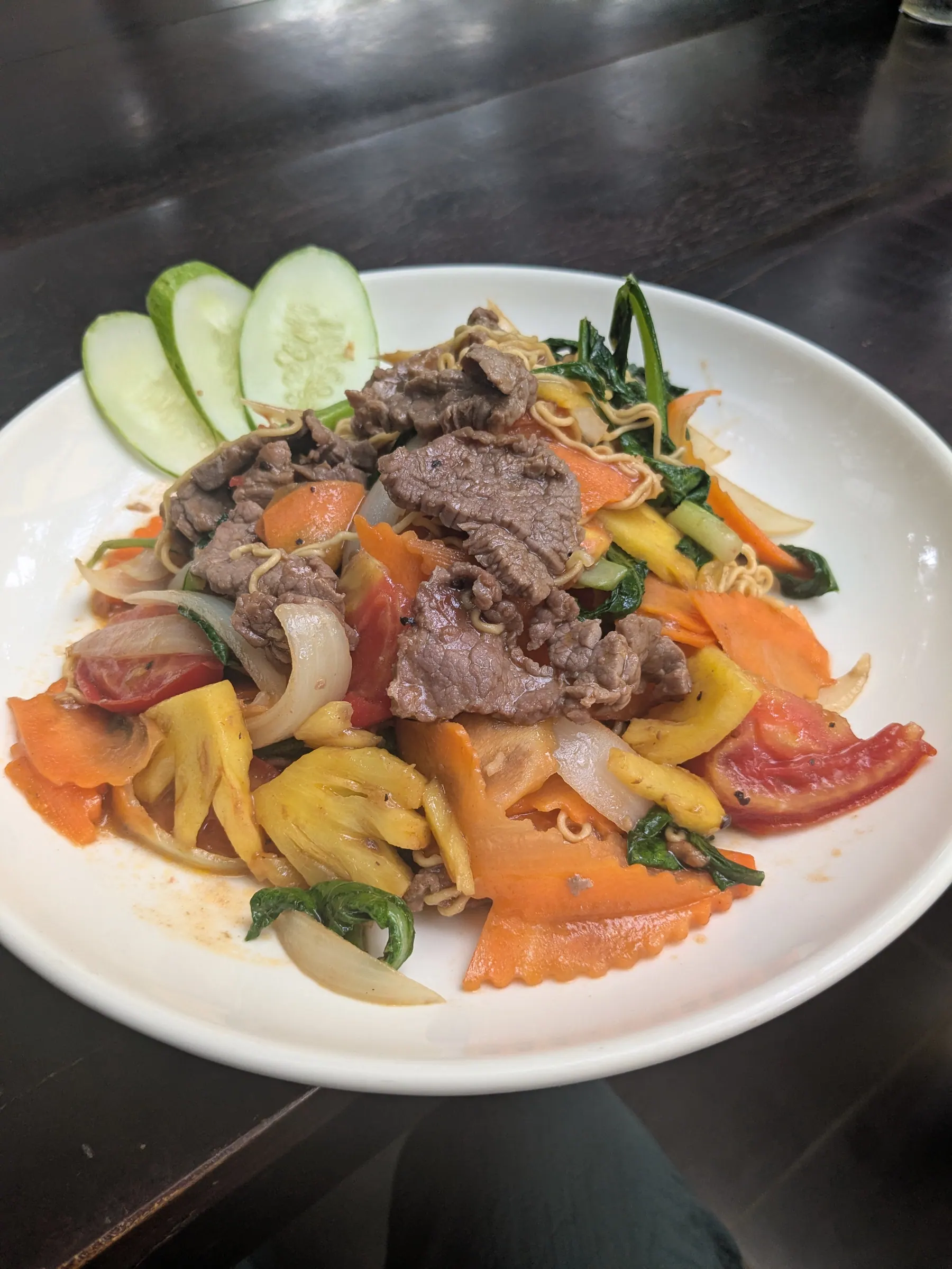 A bowl of beef noodles with vegetables at Grandma's Garden
