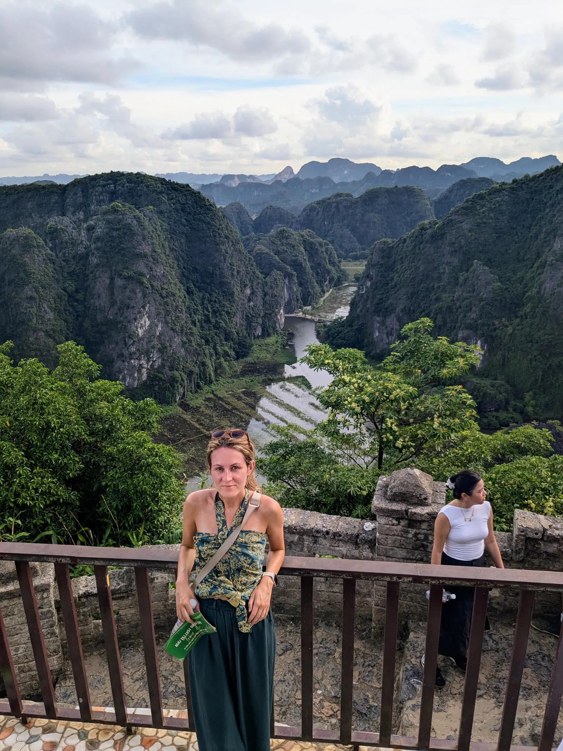 A traveller at the Mua Cave viewpoint overlooking the river valley