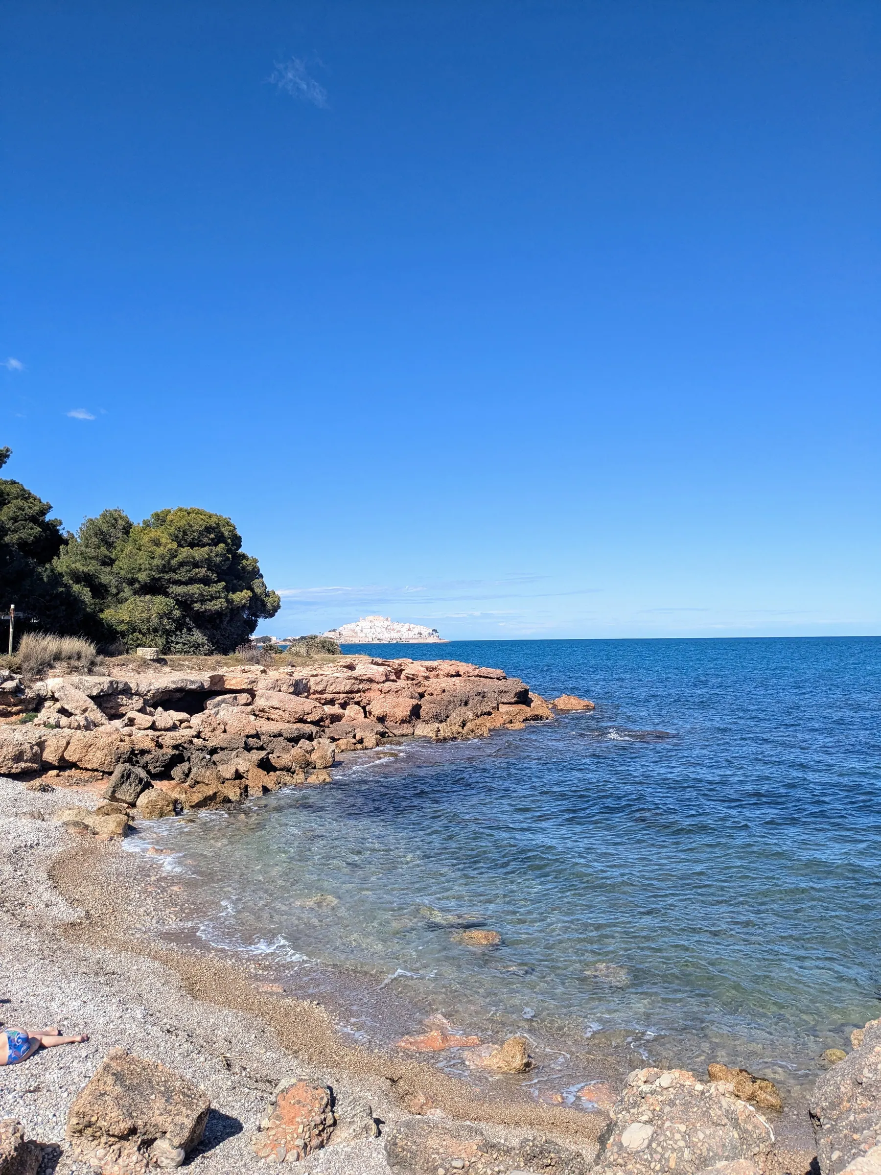 Small rocky cove with clear blue water near Peñíscola and Sierra de Irta