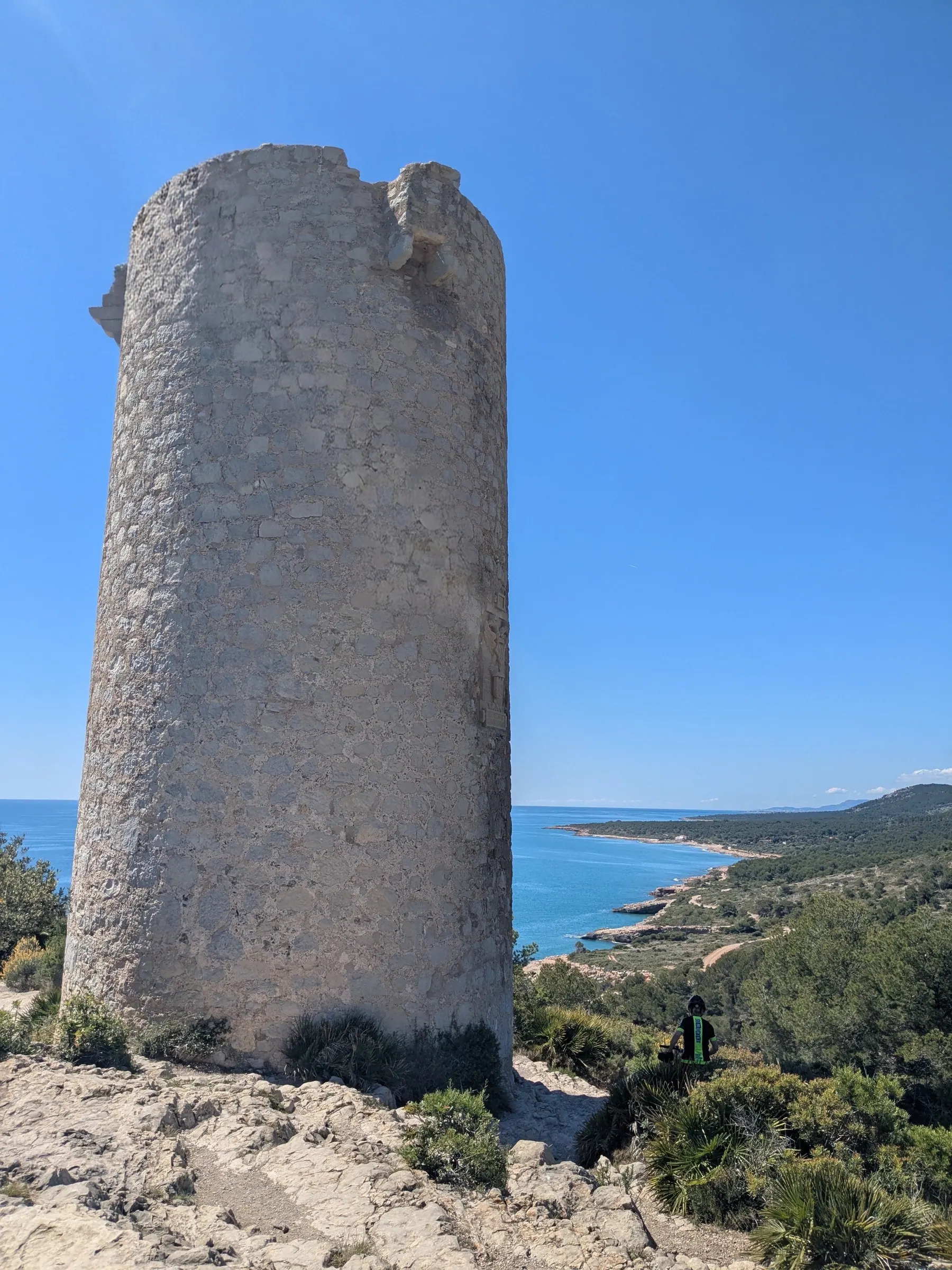 Round stone Torre Badum watchtower above the Sierra de Irta coast