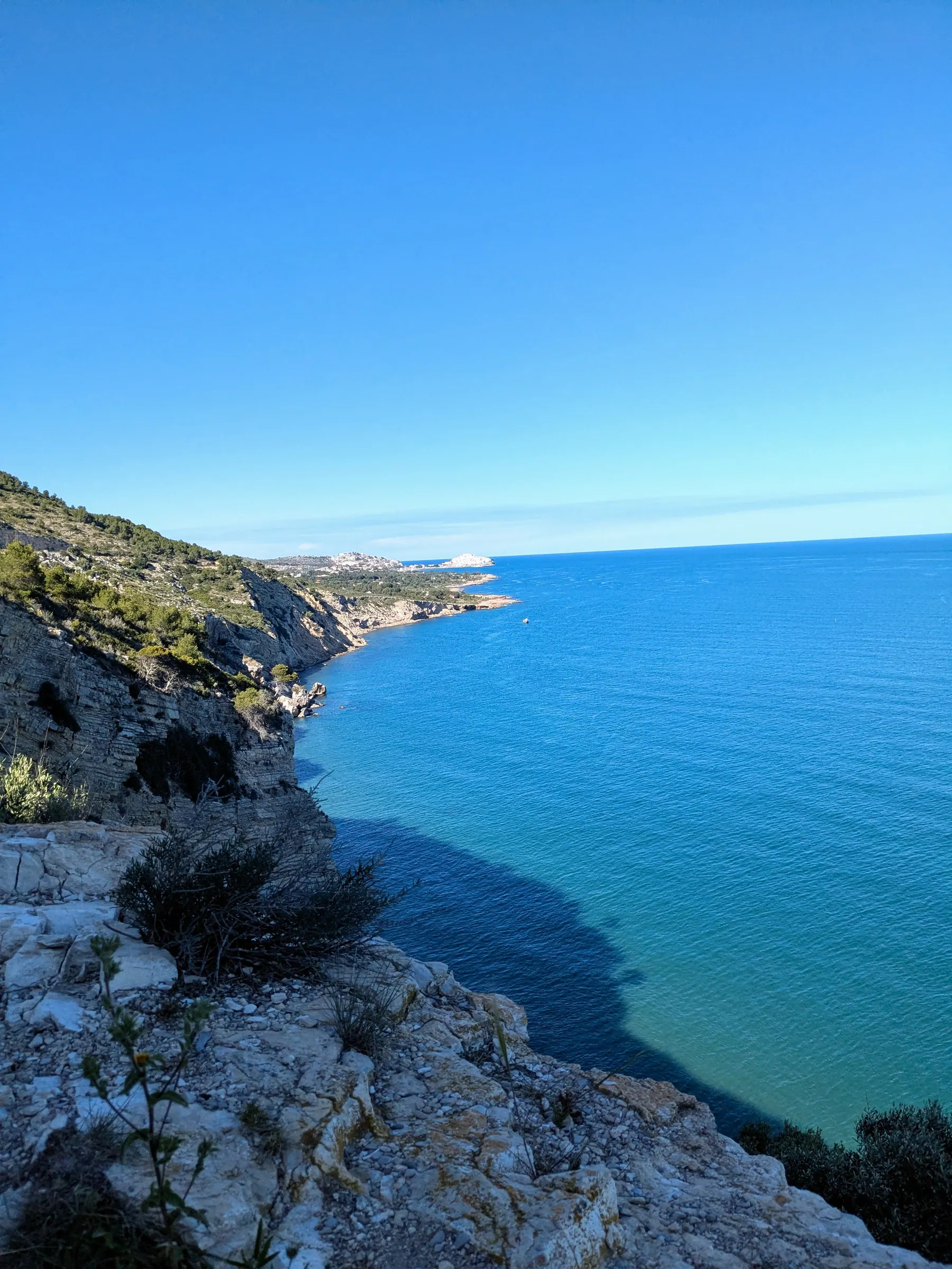 Blue Mediterranean and cliffs viewed from the path beyond Torre Badum