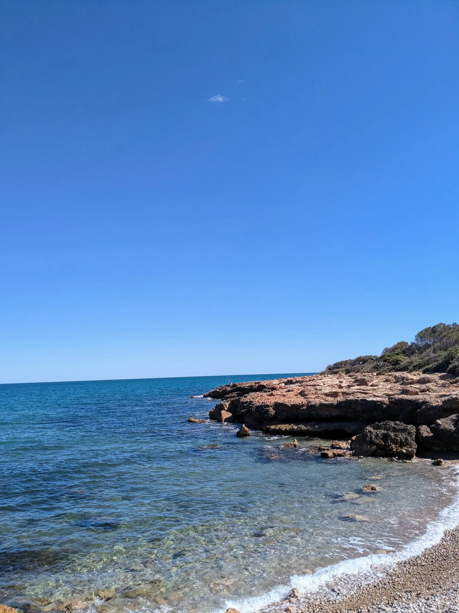 Clear Mediterranean water at a small rocky beach in Sierra de Irta