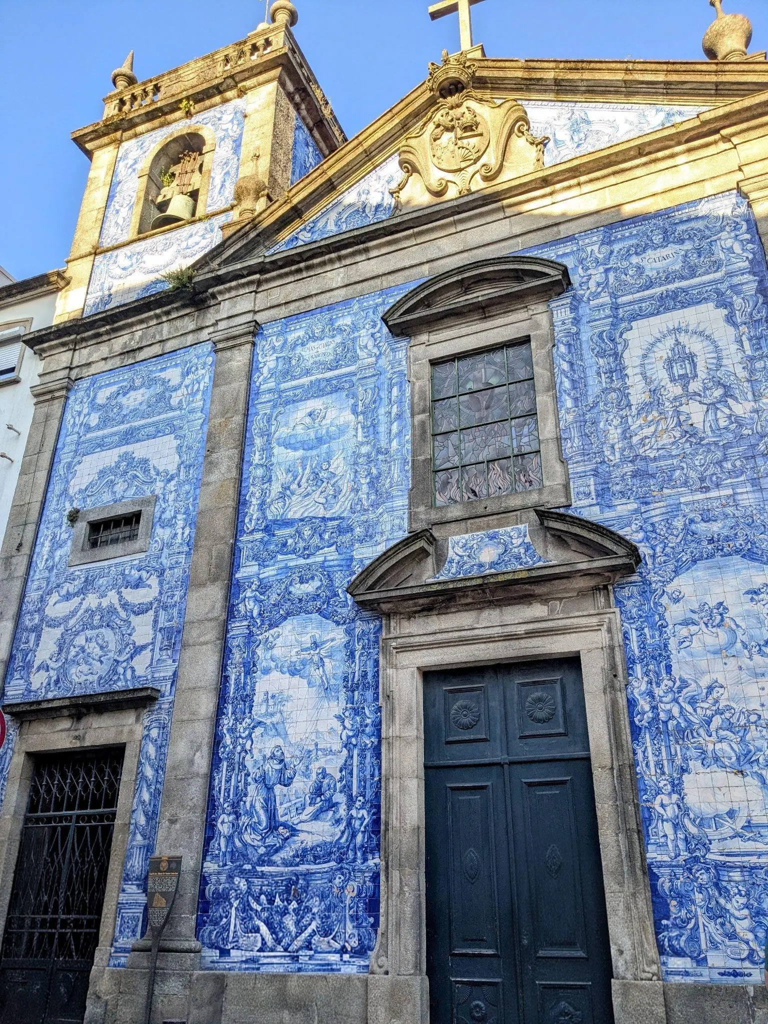 The blue and white azulejo facade of the Chapel of Souls in Porto