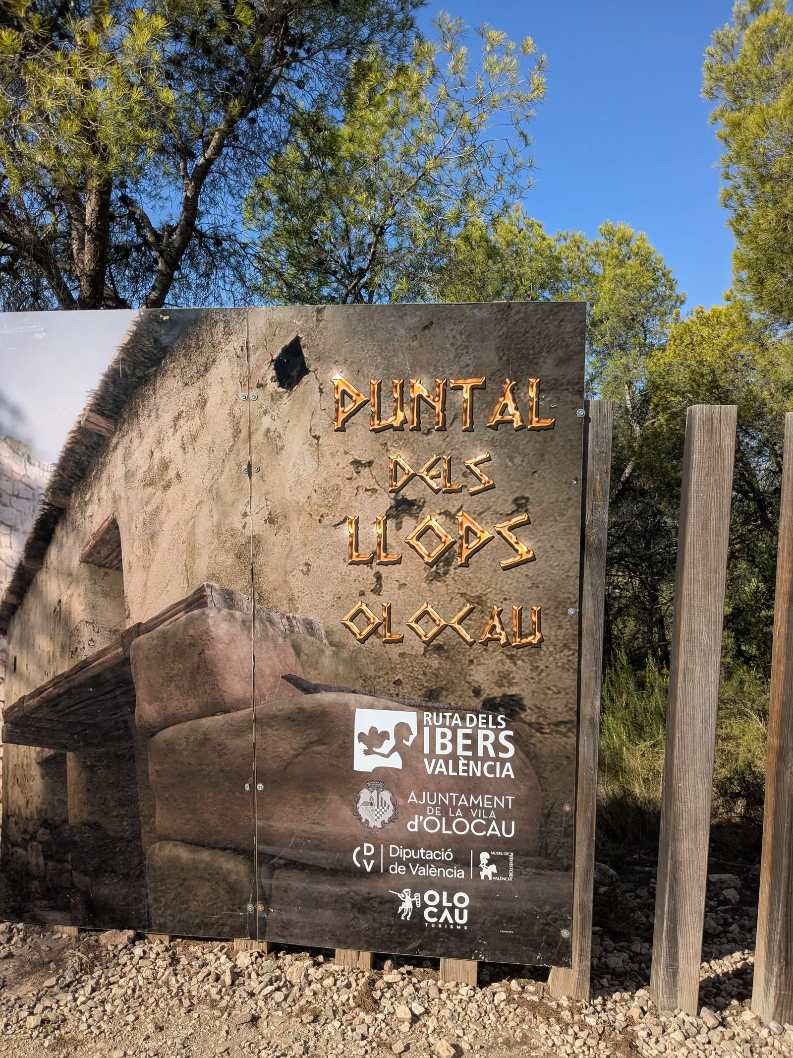 Cartel de madera del Puntal dels Llops entre los pinos cerca de Olocau